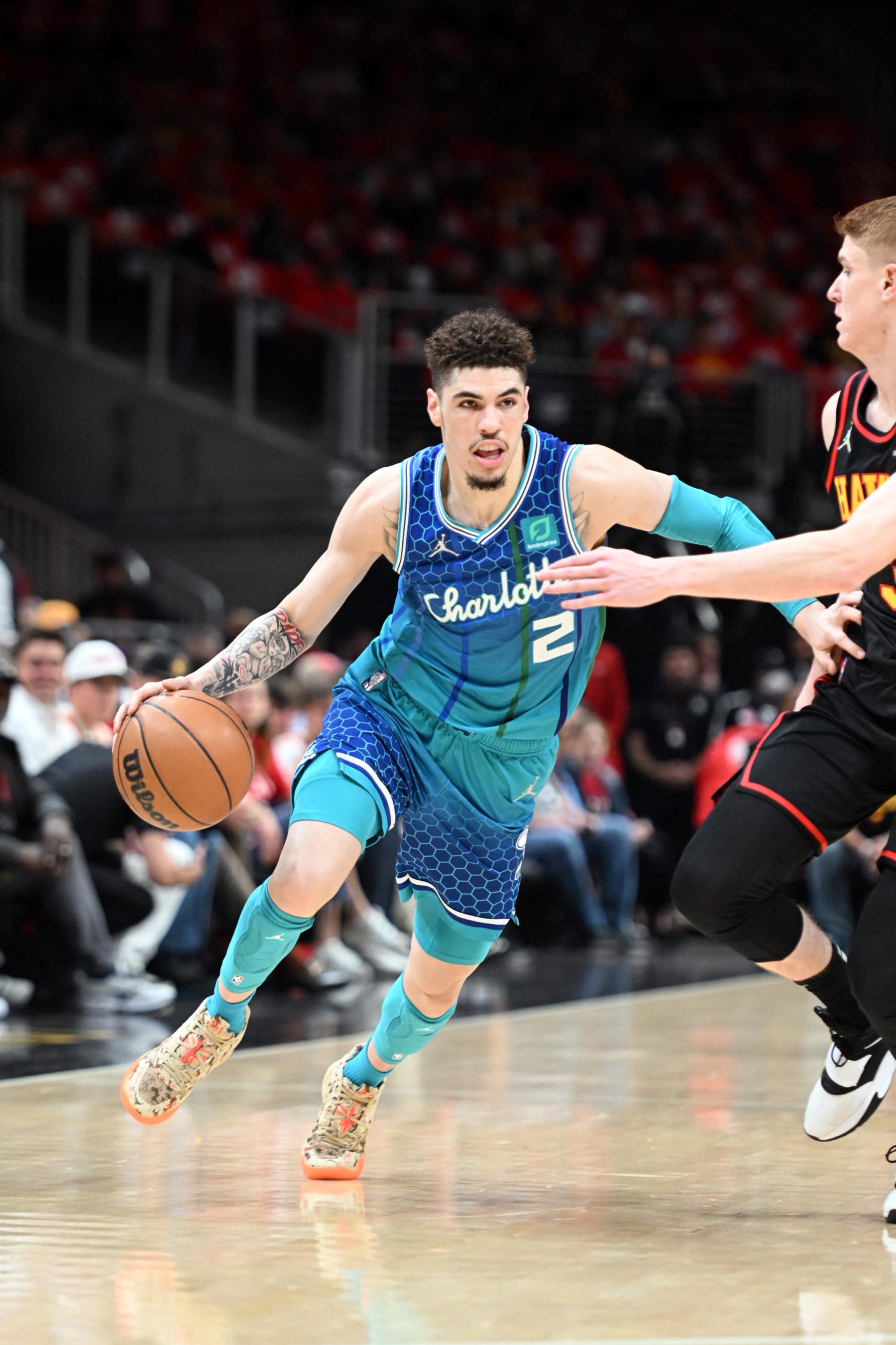 ATLANTA, GA - APRIL 13: LaMelo Ball #2 of the Charlotte Hornets dribbles the ball during the game against the Atlanta Hawks during the 2022 Play-In Tournament on April 13, 2022 at State Farm Arena in Atlanta, Georgia.  NOTE TO USER: User expressly acknowledges and agrees that, by downloading and/or using this Photograph, user is consenting to the terms and conditions of the Getty Images License Agreement. Mandatory Copyright Notice: Copyright 2022 NBAE (Photo by Adam Hagy/NBAE via Getty Images)