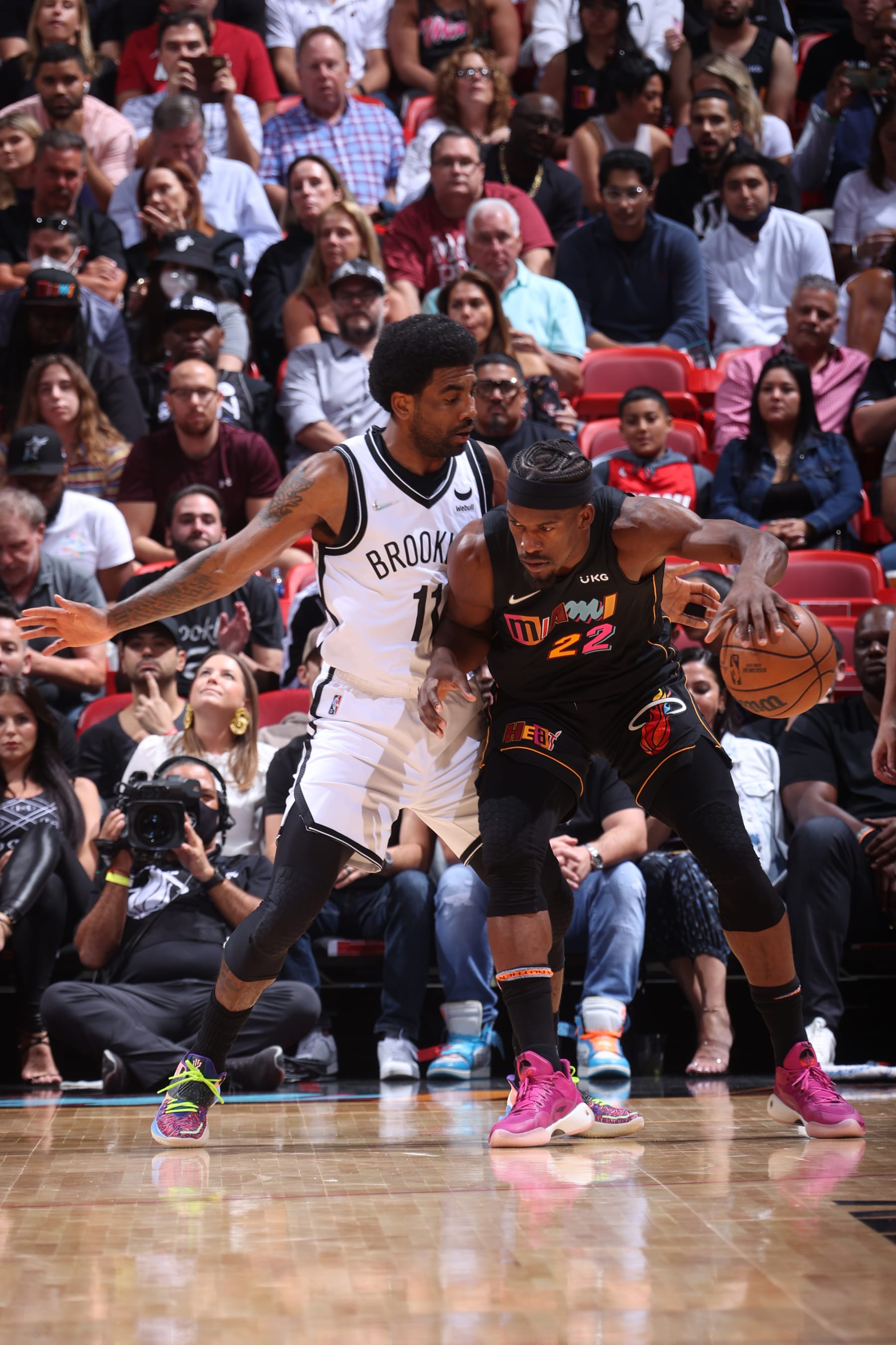 MIAMI, FL - MARCH 26: Kyrie Irving #11 of the Brooklyn Nets plays defense on Jimmy Butler #22 of the Miami Heat during the game on March 26, 2022 at FTX Arena in Miami, Florida. NOTE TO USER: User expressly acknowledges and agrees that, by downloading and or using this Photograph, user is consenting to the terms and conditions of the Getty Images License Agreement. Mandatory Copyright Notice: Copyright 2022 NBAE (Photo by Nathaniel S. Butler/NBAE via Getty Images)