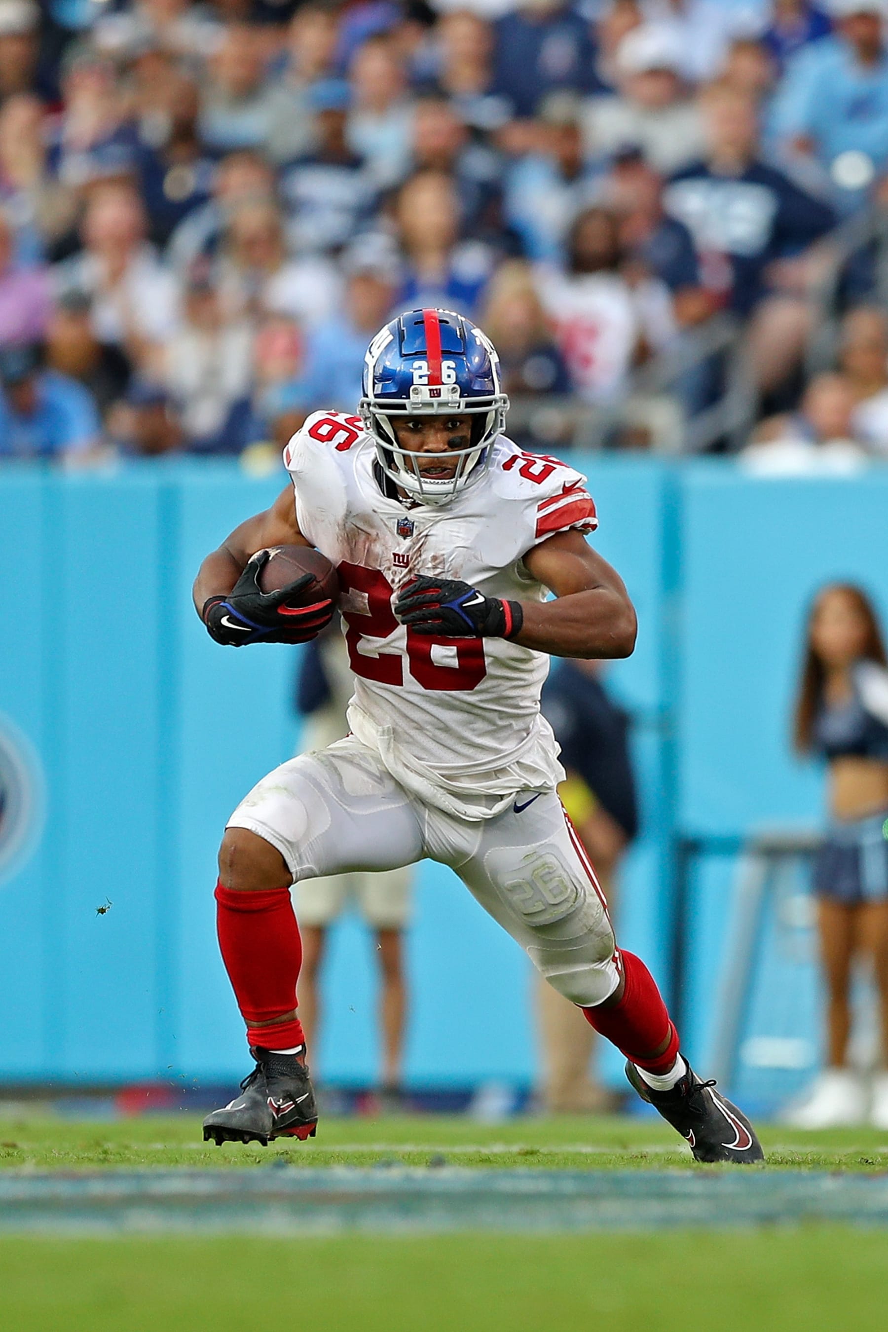 NASHVILLE, TENNESSEE - SEPTEMBER 11: Saquon Barkley #26 of the New York Giants carries the ball during the game against the Tennessee Titans at Nissan Stadium on September 11, 2022 in Nashville, Tennessee. (Photo by Justin Ford/Getty Images)