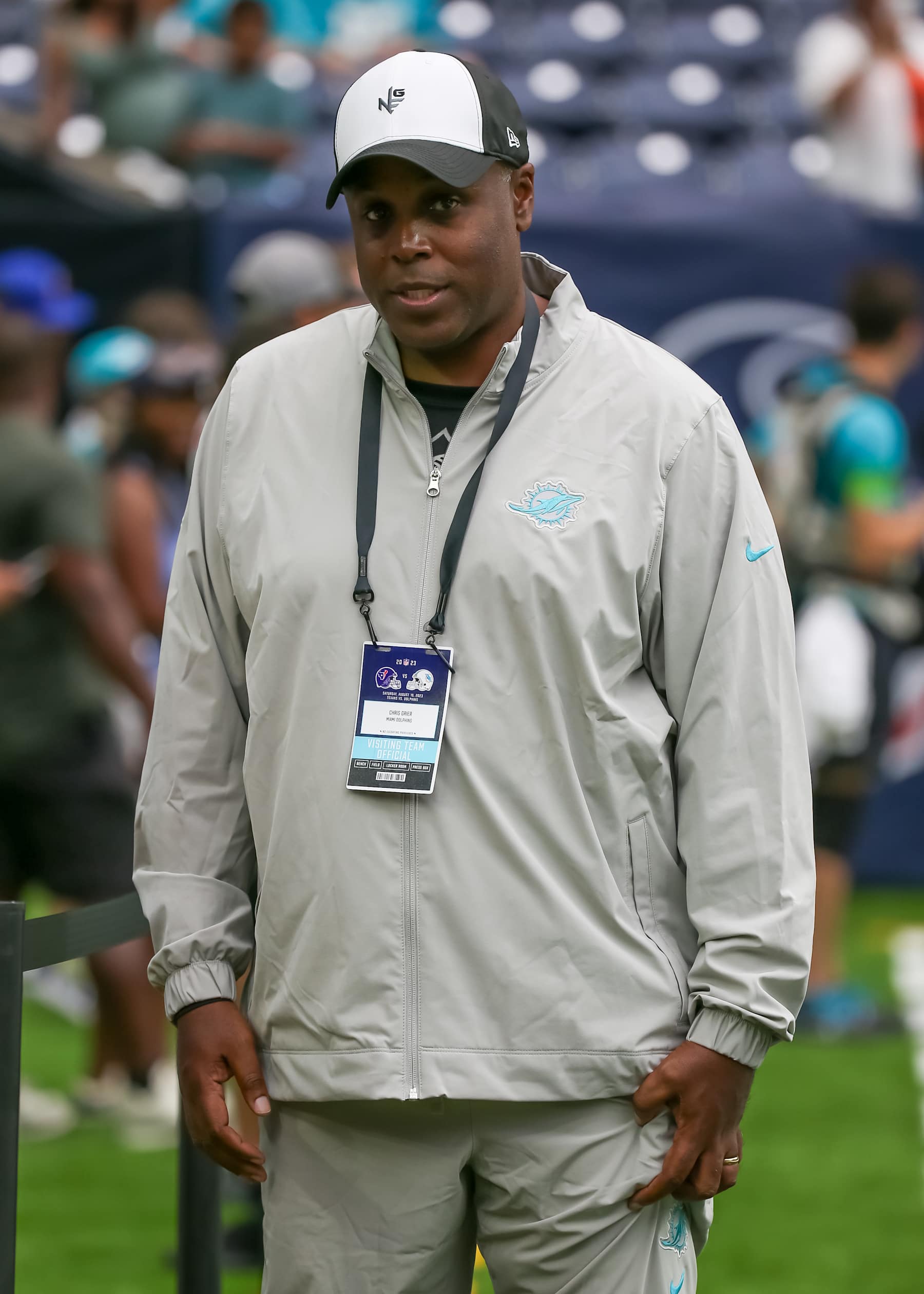 HOUSTON, TX - AUGUST 19:  Miami Dolphins general manager Chris Grier visits with fans on the sidelines during the preseason NFL game between the Miami Dolphins and Houston Texans on August 19, 2023 at NRG Stadium in Houston, Texas.  (Photo by Leslie Plaza Johnson/Icon Sportswire via Getty Images)