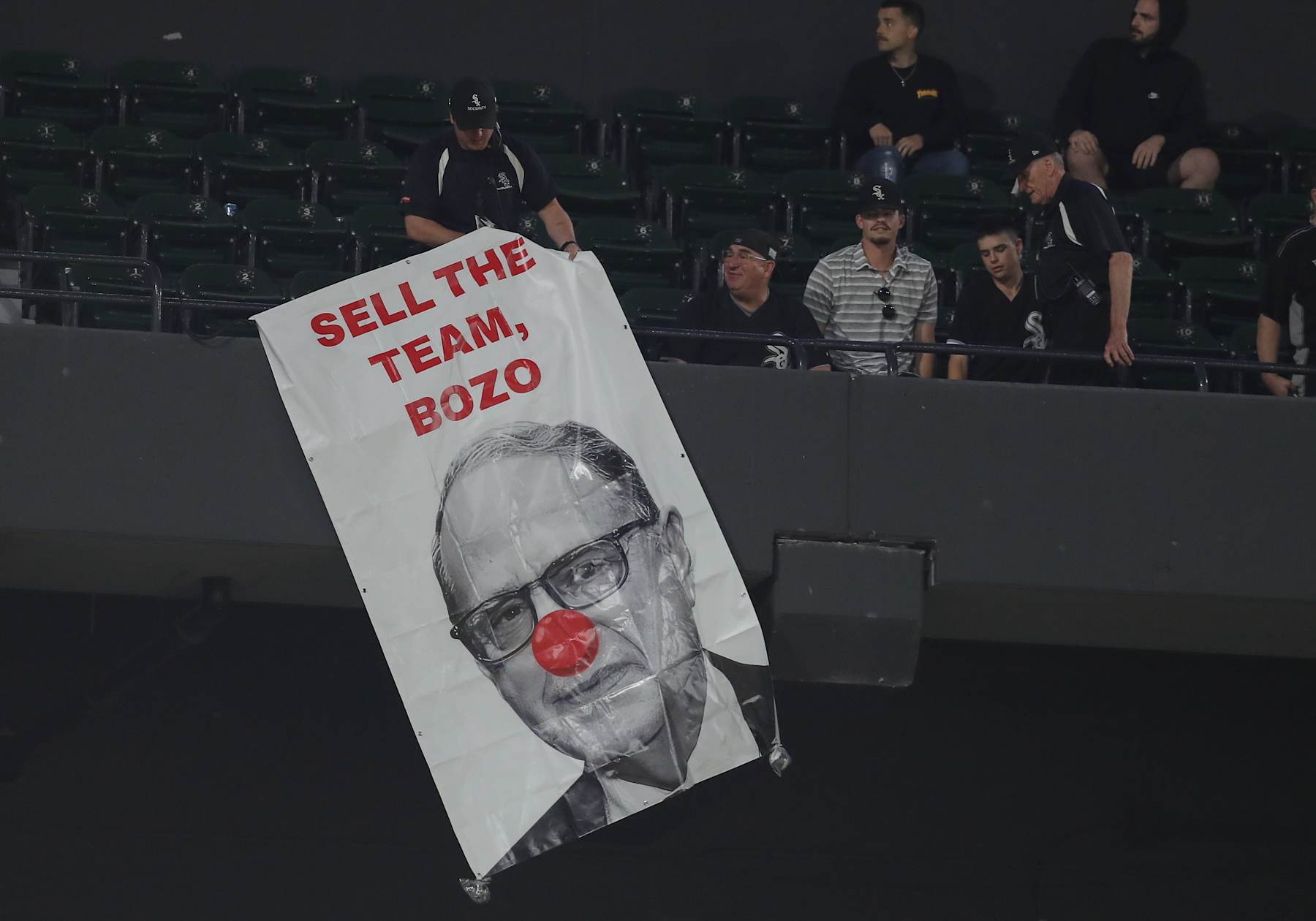 CHICAGO, IL - MAY 23: Security removes a sign that is hung from the upper deck of Chicago White Sox Chairperson Jerry Reinsdorf in the ninth inning during a game against the Baltimore Orioles and the Chicago White Sox on May 23, 2024 at Guaranteed Rate Field in Chicago, Illinois. (Photo by Melissa Tamez/Icon Sportswire via Getty Images)
