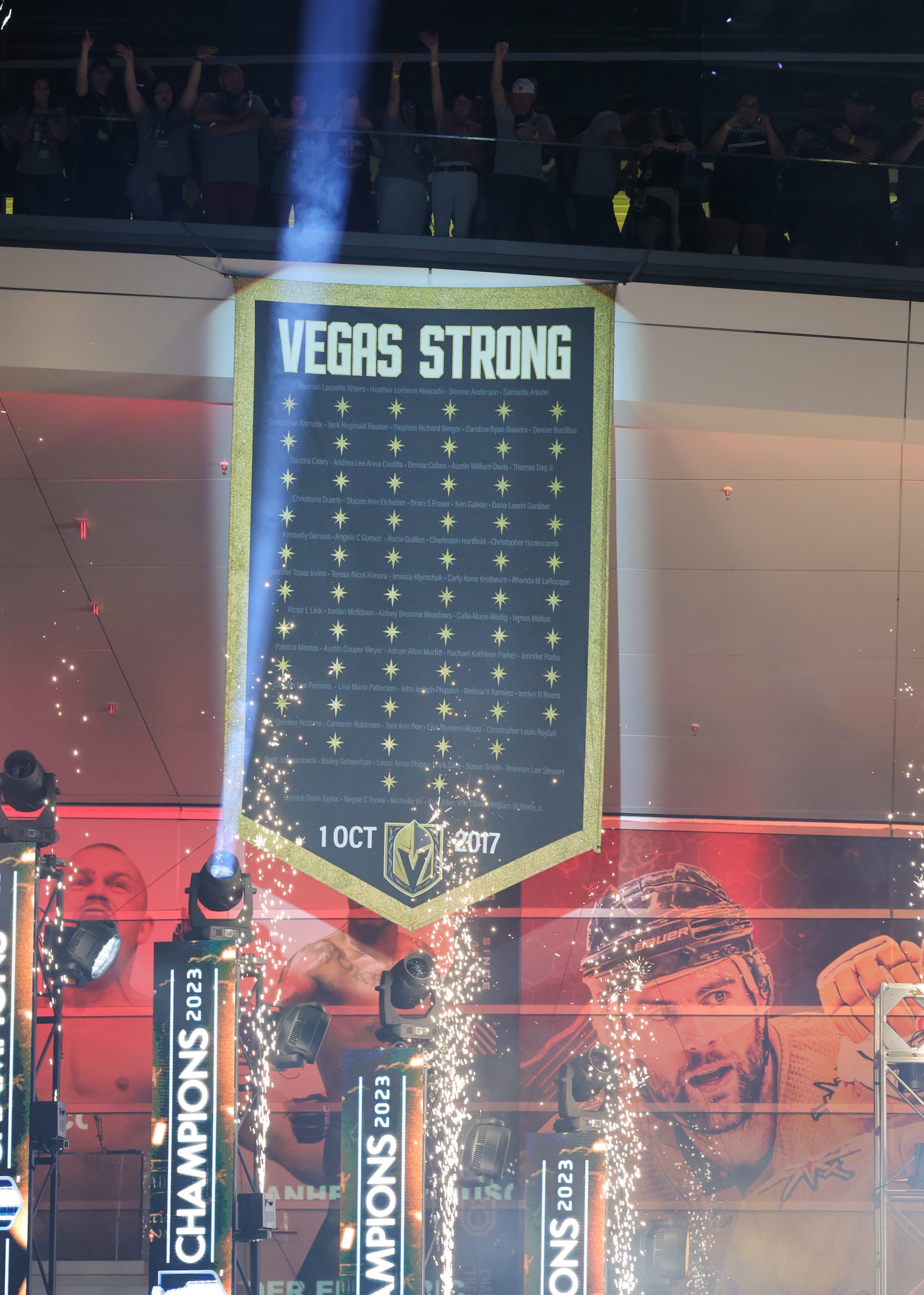 LAS VEGAS, NEVADA - JUNE 17: Fans acknowledge a "Vegas Strong" banner honoring the 60 victims of the October 1, 2017, mass shooting on the Las Vegas Strip during a victory parade and rally for the Vegas Golden Knights outside T-Mobile Arena on June 17, 2023 in Las Vegas, Nevada. The Golden Knights defeated the Florida Panthers four games to one to win the 2023 NHL Stanley Cup Final. (Photo by Ethan Miller/Getty Images)