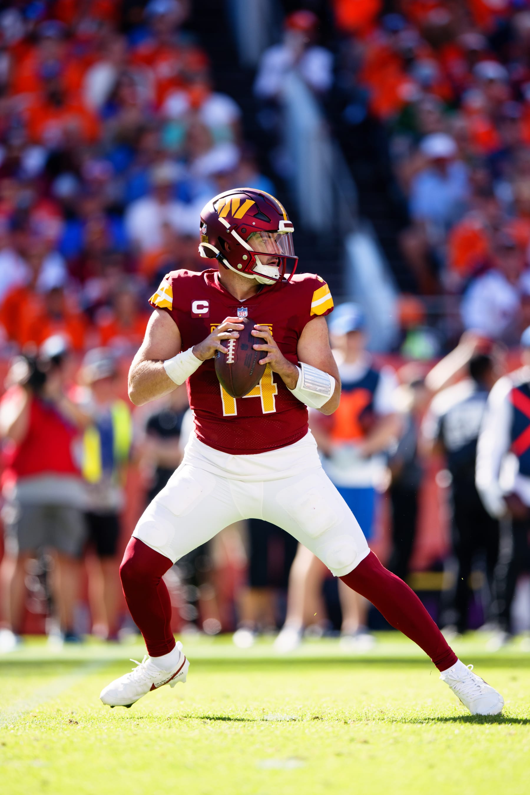 DENVER, CO - SEPTEMBER 17:  Quarterback Sam Howell #14 of the Washington Commanders drops back to pass during the second quarter against the Denver Broncos at Empower Field at Mile High on September 17, 2023 in Denver, Colorado. (Photo by Justin Edmonds/Getty Images)