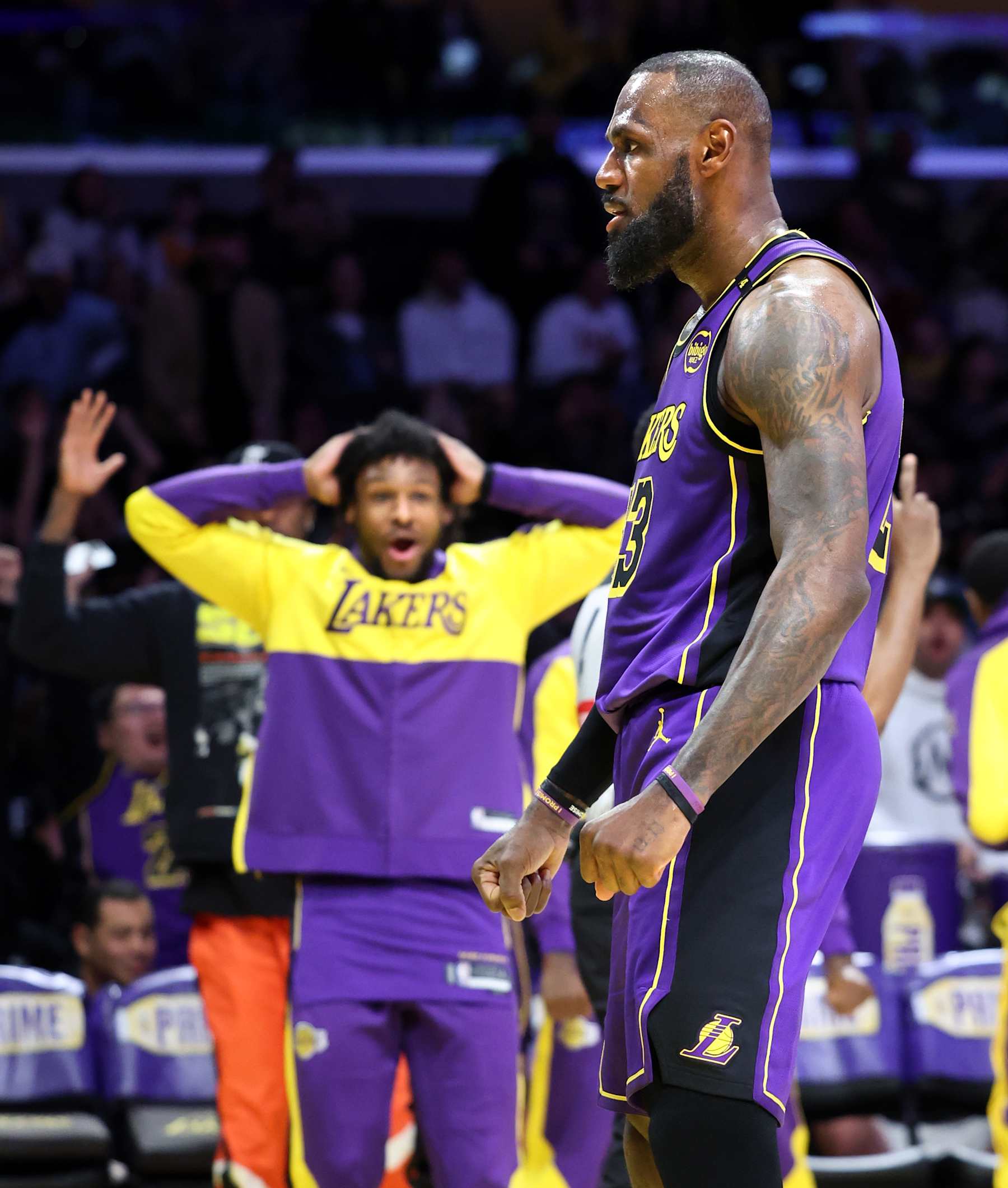 Los Angeles, California January 21, 2025-Lakers LeBron James celebrates his dunk while getting fouled against the Wizards as son Ronny cheers I the background in the second quarter at Crypto.com Arena Tuesday. (Wally Skalij/Los Angeles Times via Getty Images)