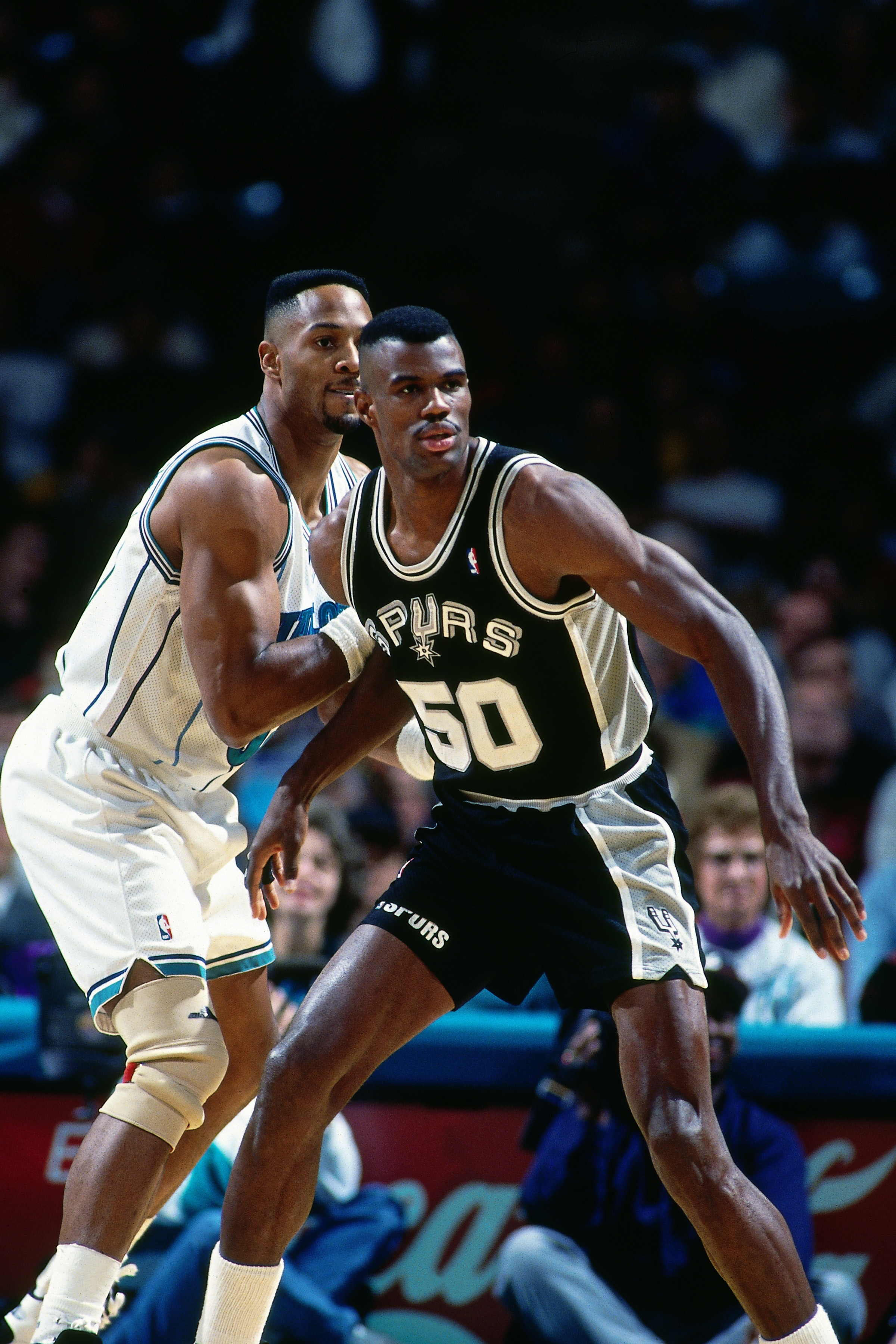 CHARLOTTE, NC - DECEMBER 1: David Robinson #50 of the San Antonio Spurs battles for position against the Charlotte Hornets on December 1, 1993 at Charlotte Coliseum in Charlotte, NC. NOTE TO USER: User expressly acknowledges and agrees that, by downloading and/or using this photograph, user is consenting to the terms and conditions of the Getty Images License Agreement.  Mandatory Copyright Notice: Copyright 1994 NBAE (Photo by Gregg Forwerck/NBAE via Getty Images)