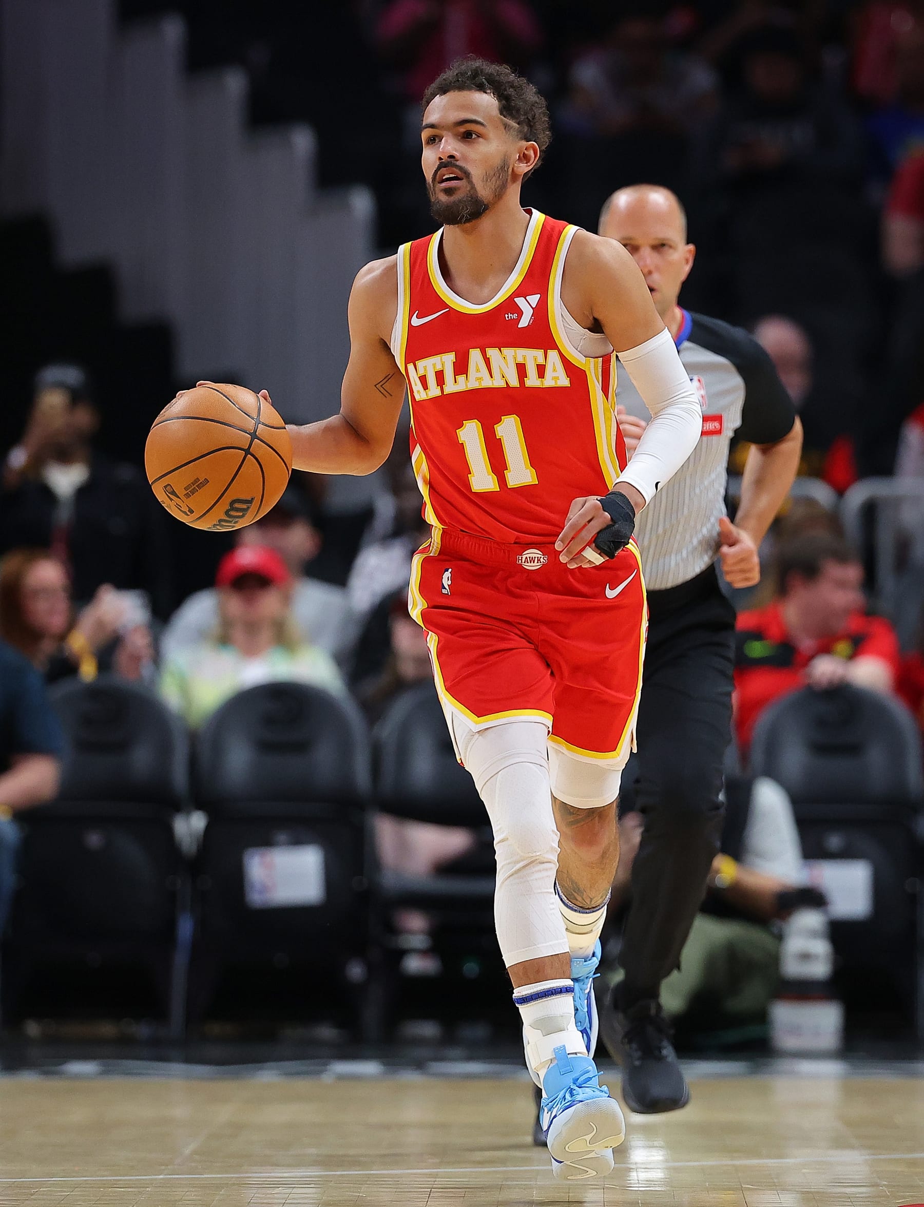 ATLANTA, GEORGIA - APRIL 10:  Trae Young #11 of the Atlanta Hawks pushes the ball up the court against the Charlotte Hornets during the first quarter at State Farm Arena on April 10, 2024 in Atlanta, Georgia.  NOTE TO USER: User expressly acknowledges and agrees that, by downloading and/or using this photograph, user is consenting to the terms and conditions of the Getty Images License Agreement.  (Photo by Kevin C. Cox/Getty Images)