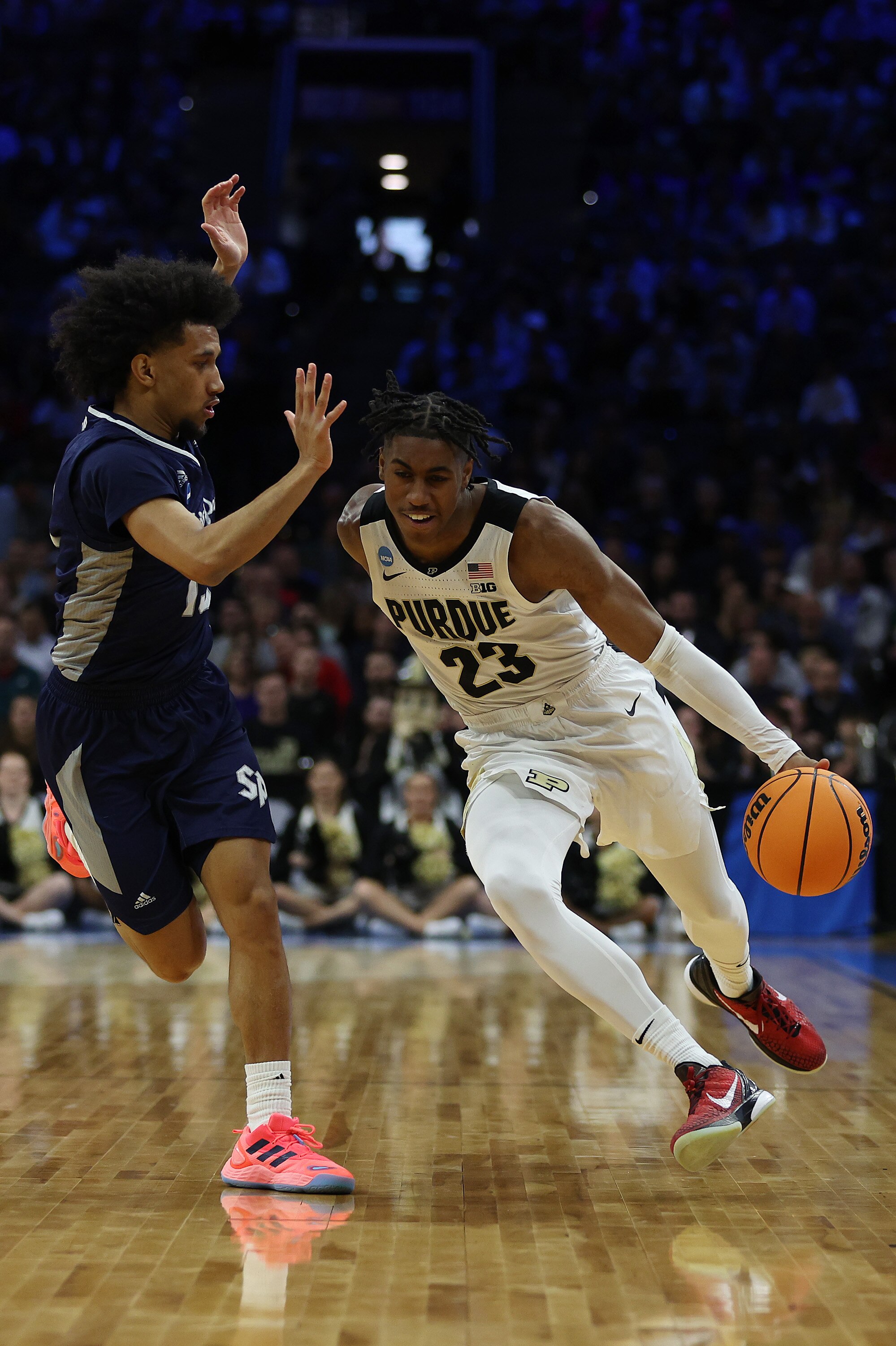 PHILADELPHIA, PENNSYLVANIA - MARCH 25: Jaden Ivey #23 of the Purdue Boilermakers dribbles the ball as Matthew Lee #15 of the St. Peter's Peacocks defends in the first half of the game in the Sweet Sixteen round of the 2022 NCAA Men's Basketball Tournament at Wells Fargo Center on March 25, 2022 in Philadelphia, Pennsylvania. (Photo by Patrick Smith/Getty Images)