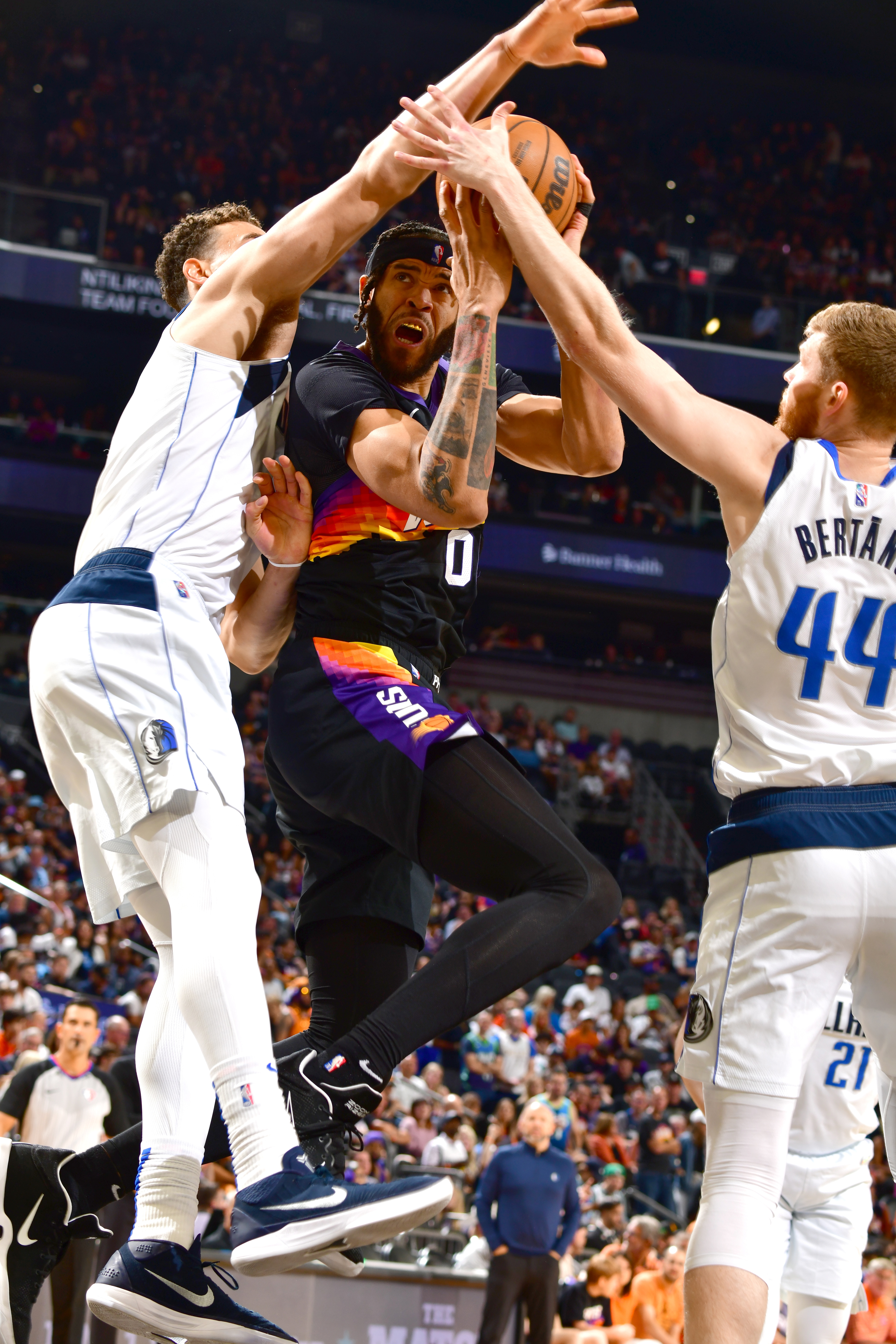 PHOENIX, AZ - MAY 15: Davis Bertans #44 of the Dallas Mavericks blocks the shot of JaVale McGee #00 of the Phoenix Suns during Game 7 of the 2022 NBA Playoffs Western Conference Semifinals on May 15, 2022 at Footprint Center in Phoenix, Arizona. NOTE TO USER: User expressly acknowledges and agrees that, by downloading and or using this photograph, user is consenting to the terms and conditions of the Getty Images License Agreement. Mandatory Copyright Notice: Copyright 2022 NBAE (Photo by Barry Gossage/NBAE via Getty Images)