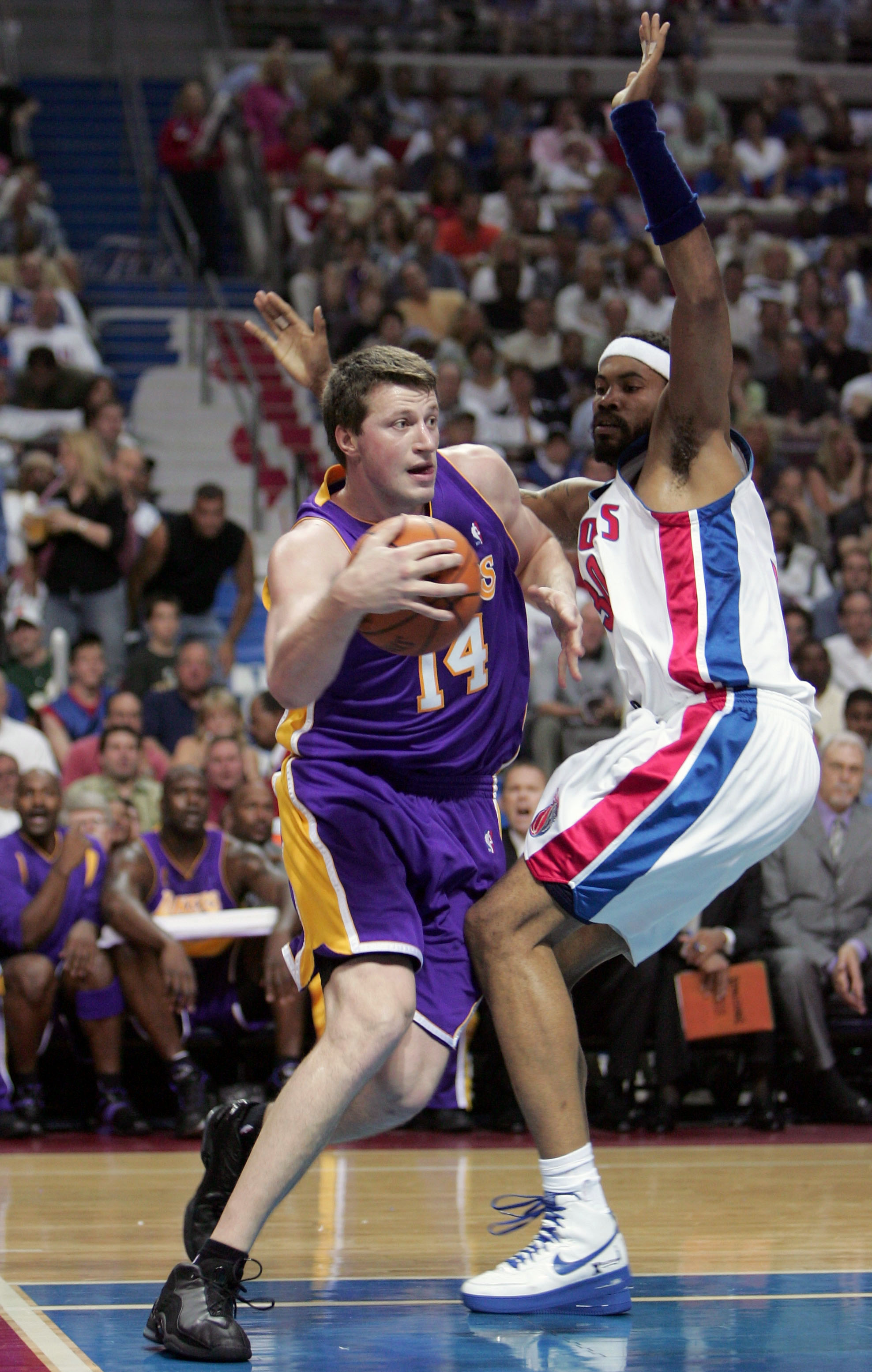 AUBURN HILLS, MI - JUNE 15:   Slava Medvedenko #14 of the Los Angeles Lakers drives past Rasheed Wallace #30 of the Detroit Pistons in the first quarter of game five of the 2004 NBA Finals on June 15, 2004 at The Palace of Auburn Hills in Auburn Hills, Michigan.  NOTE TO USER: User expressly acknowledges and agrees that, by downloading and or using this photograph, User is consenting to the terms and conditions of the Getty Images License Agreement.  (Photo by Jed Jacobsohn/Getty Images)