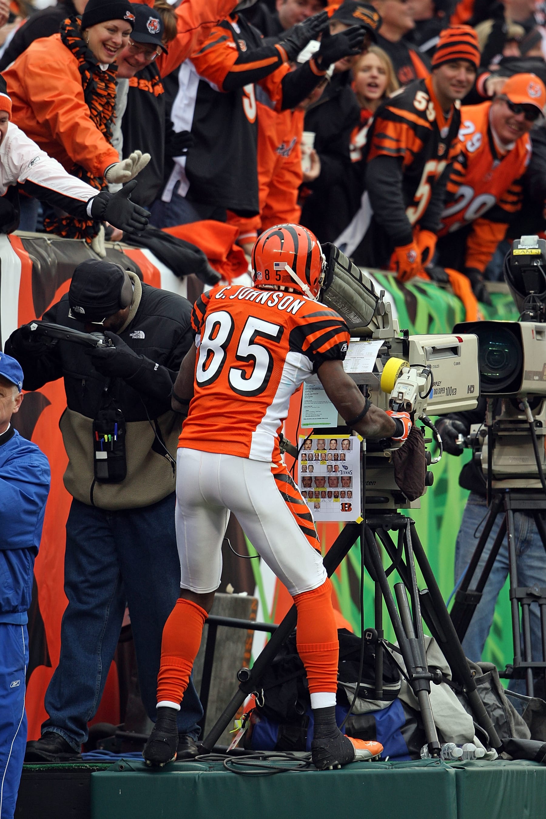CINCINNATI - NOVEMBER 25:  Chad Johnson #85 of the Cincinnati Bengals celebrates after catching a touchdown pass by taking over a television camera during the NFL game against the Tennessee Titans on November 25, 2007 at Paul Brown Stadium in Cincinnati, Ohio.  (Photo by Andy Lyons/Getty Images)