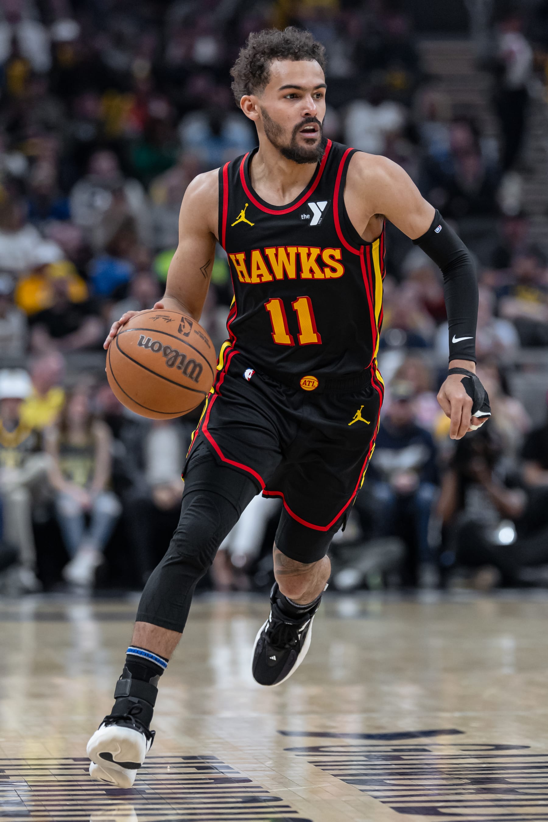 INDIANAPOLIS, INDIANA - APRIL 14: Trae Young #11 of the Atlanta Hawks brings the ball up court during the game against the Indiana Pacers at Gainbridge Fieldhouse on April 14, 2024 in Indianapolis, Indiana. NOTE TO USER: User expressly acknowledges and agrees that, by downloading and or using this photograph, User is consenting to the terms and conditions of the Getty Images License Agreement. (Photo by Michael Hickey/Getty Images)