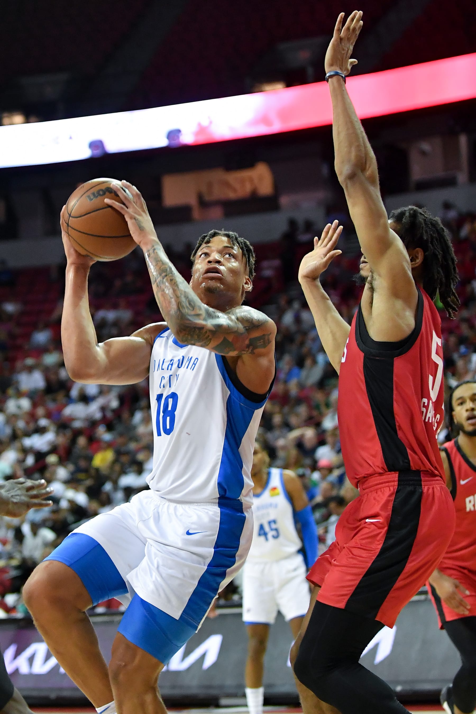 LAS VEGAS, NEVADA - JULY 11: Keyontae Johnson #18 of the Oklahoma City Thunder shoots over Jermaine Samuels Jr. #57 of the Houston Rockets at the Thomas & Mack Center on July 11, 2023 in Las Vegas, Nevada. NOTE TO USER: User expressly acknowledges and agrees that, by downloading and or using this photograph, User is consenting to the terms and conditions of the Getty Images License Agreement. (Photo by Allen Berezovsky/Getty Images)