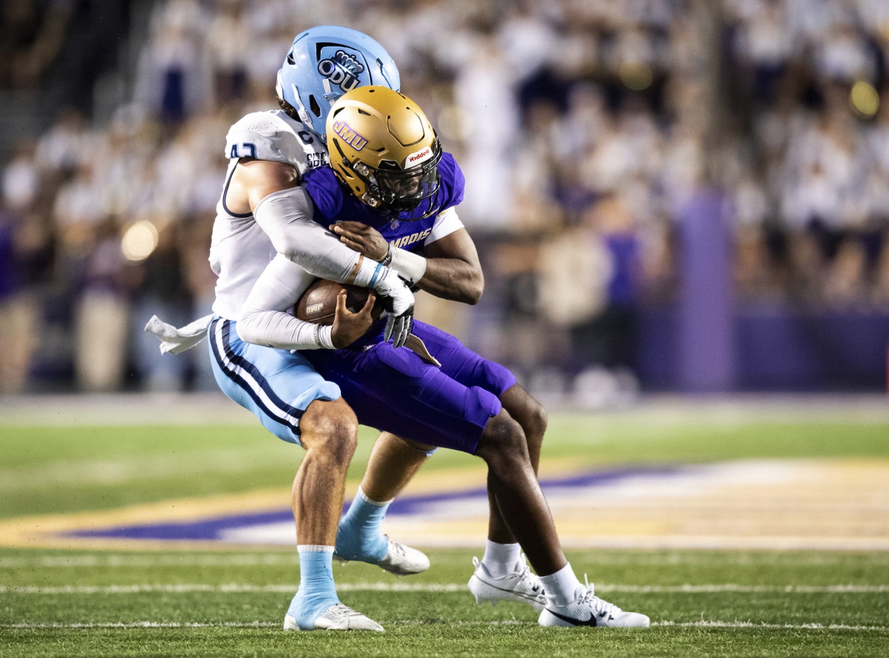 James Madison quarterback Jordan McCloud, right, is sacked by Old Dominion linebacker Jason Henderson during the first half of an NCAA college football game Saturday, Oct. 28, 2023, in Harrisonburg, Va. (AP Photo/Mike Caudill)