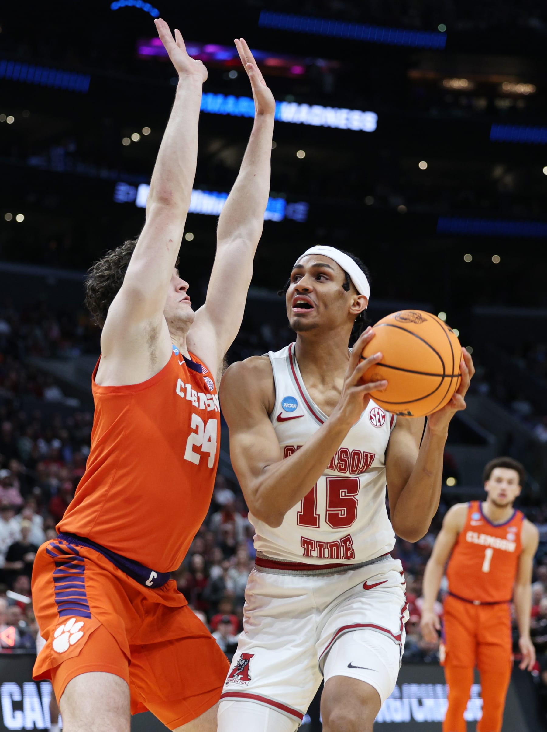 LOS ANGELES, CALIFORNIA - MARCH 30: Jarin Stevenson #15 of the Alabama Crimson Tide handles the ball against PJ Hall #24 of the Clemson Tigers during the first half in the Elite 8 round of the NCAA Men's Basketball Tournament at Crypto.com Arena on March 30, 2024 in Los Angeles, California. (Photo by Harry How/Getty Images)