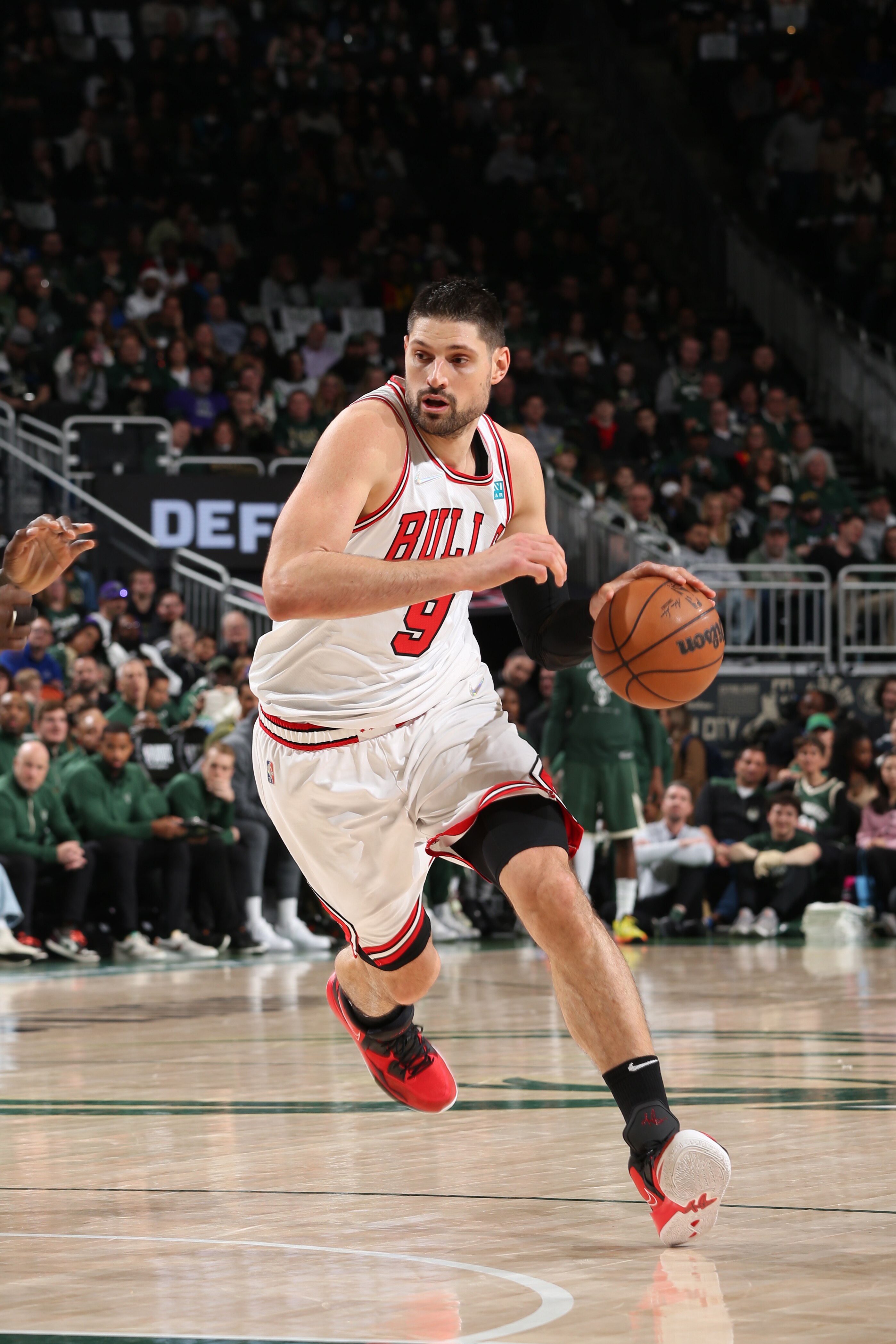 MILWAUKEE, WI - APRIL 27: Nikola Vucevic #9 of the Chicago Bulls drives to the basket against the Milwaukee Bucks during Round 1 Game 5 of the 2022 NBA Playoffs on April 27, 2022 at the Fiserv Forum Center in Milwaukee, Wisconsin. NOTE TO USER: User expressly acknowledges and agrees that, by downloading and or using this Photograph, user is consenting to the terms and conditions of the Getty Images License Agreement. Mandatory Copyright Notice: Copyright 2022 NBAE (Photo by Gary Dineen/NBAE via Getty Images).