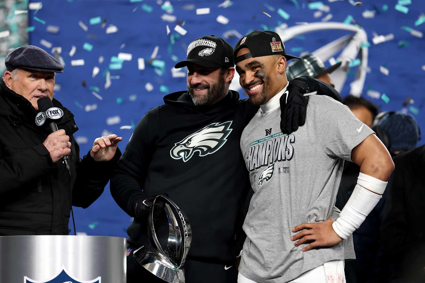 PHILADELPHIA, PENNSYLVANIA - JANUARY 26: Head coach Nick Sirianni and Jalen Hurts #1 of the Philadelphia Eagles smile during the trophy ceremony after defeating the Washington Commanders 55-23 to win the NFC Championship Game at Lincoln Financial Field on January 26, 2025 in Philadelphia, Pennsylvania.  (Photo by Emilee Chinn/Getty Images)