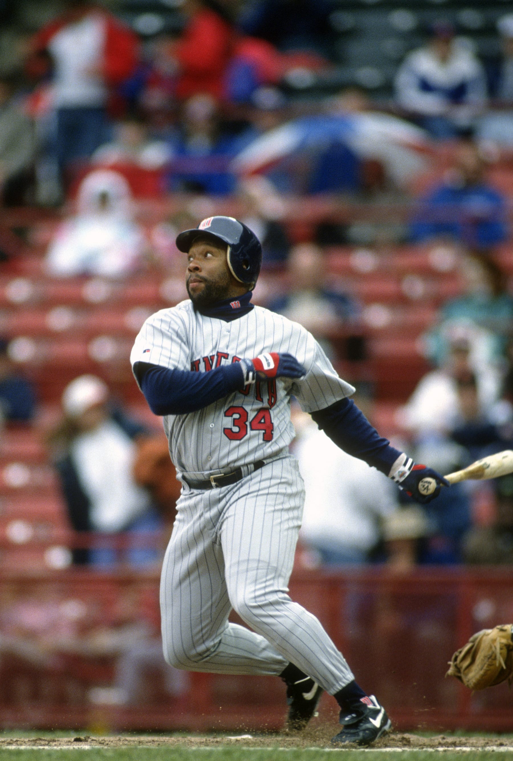 MILWAUKEE, WI - CIRCA 1993: Outfielder Kirby Puckett #34 of the Minnesota Twins swings and watches the flight of his ball against the Milwaukee Brewers during a Major League Baseball game circa 1993 at Milwaukee County Stadium in Milwaukee, Wisconsin. Puckett played for the Twins  from 1984-95. (Photo by Focus on Sport/Getty Images) 