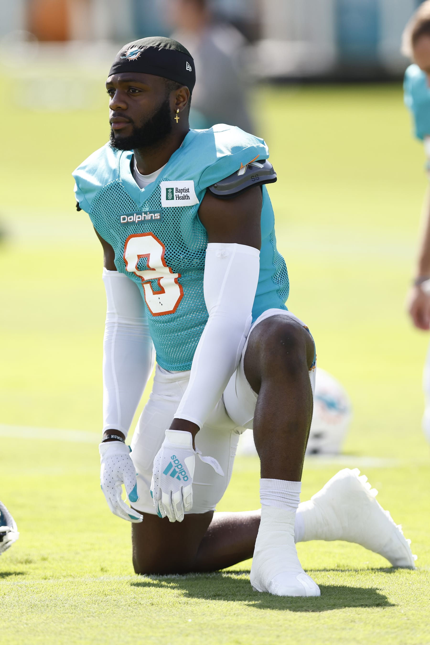 MIAMI GARDENS, FLORIDA - AUGUST 19: Noah Igbinoghene #9 of the Miami Dolphins stretches during joint practice with the Atlanta Falcons at Baptist Health Training Complex on August 19, 2021 in Miami Gardens, Florida. (Photo by Michael Reaves/Getty Images)