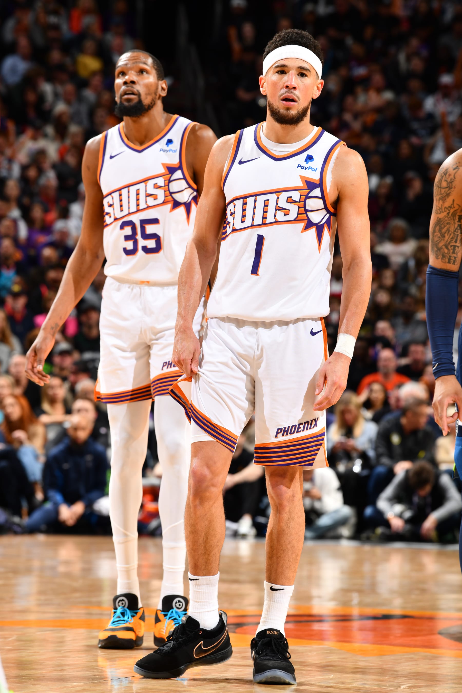 PHOENIX, AZ - APRIL 5: Devin Booker #1 and Kevin Durant #35 of the Phoenix Suns look on during the game against the Minnesota Timberwolves on April 5, 2024 at Footprint Center in Phoenix, Arizona. NOTE TO USER: User expressly acknowledges and agrees that, by downloading and or using this photograph, user is consenting to the terms and conditions of the Getty Images License Agreement. Mandatory Copyright Notice: Copyright 2024 NBAE (Photo by Barry Gossage/NBAE via Getty Images)