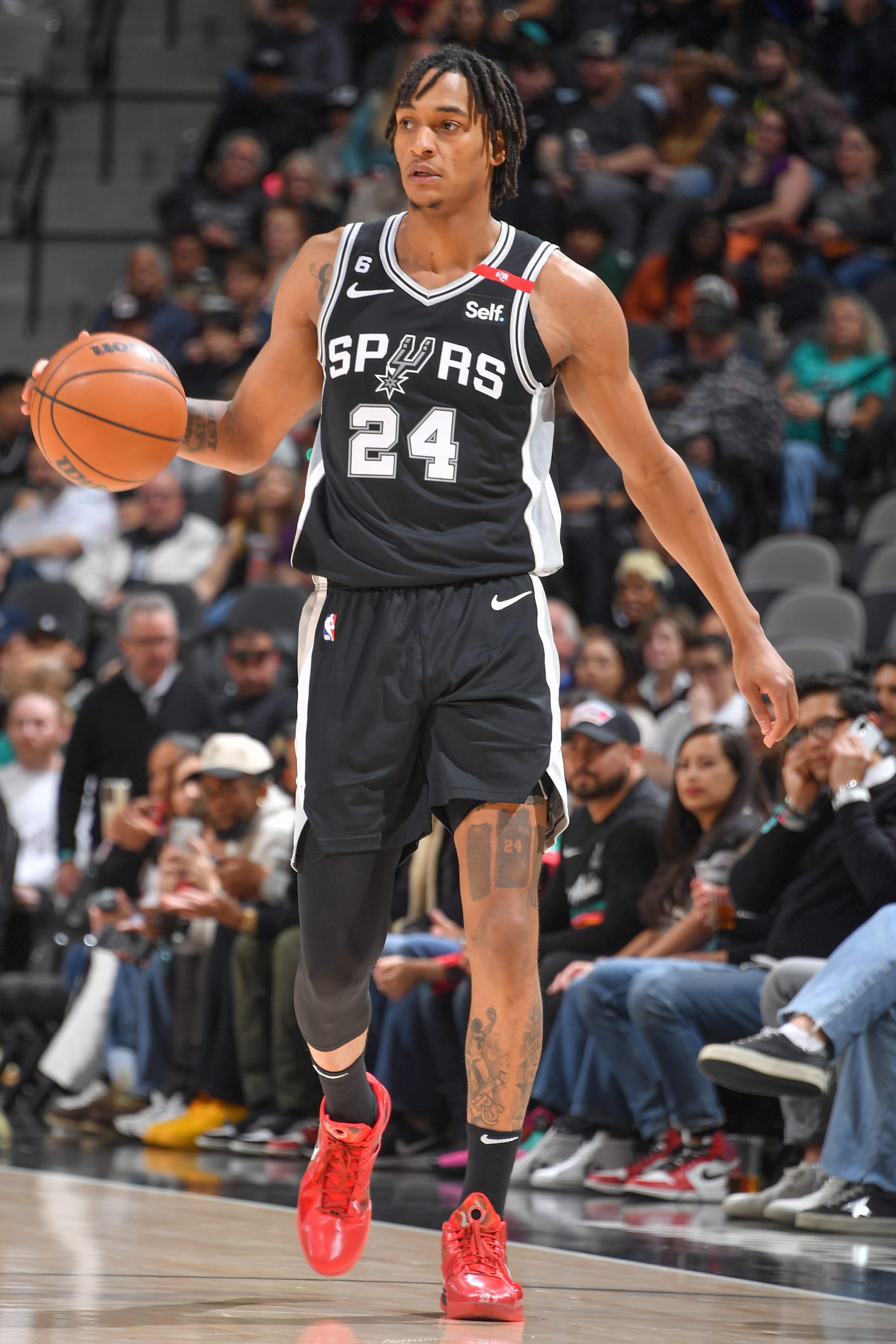 SAN ANTONIO, TX - MARCH19:  Devin Vassell #24 of the San Antonio Spurs goes to the basket during the game on March 19, 2023 at the AT&T Center in San Antonio, Texas. NOTE TO USER: User expressly acknowledges and agrees that, by downloading and or using this photograph, user is consenting to the terms and conditions of the Getty Images License Agreement. Mandatory Copyright Notice: Copyright 2023 NBAE (Photos by Michael Gonzales/NBAE via Getty Images)
