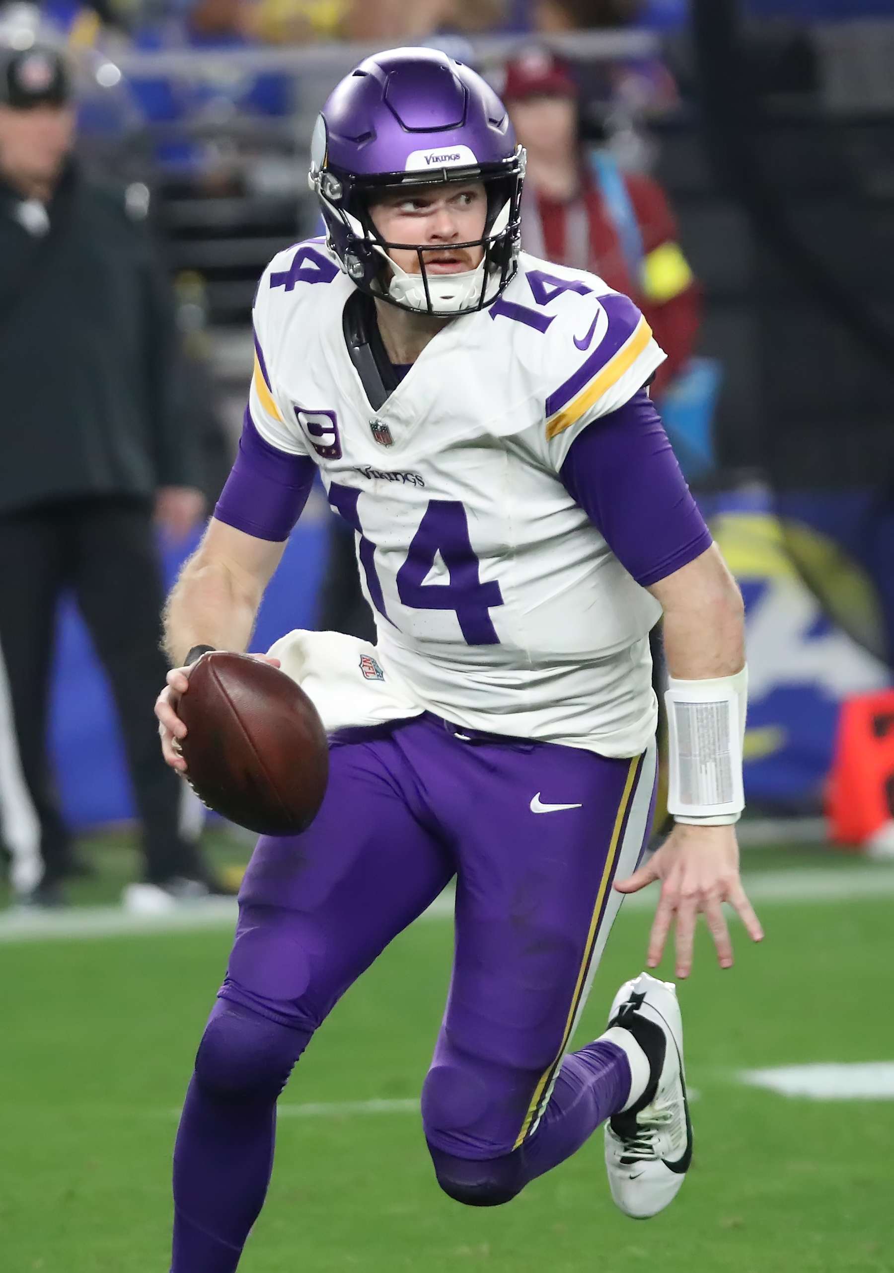 GLENDALE, ARIZONA - JANUARY 13: Quarterback Sam Darnold #14 of the Minnesota Vikings scrambles as he looks to throw a pass during the second half of the Minnesota Vikings versus Los Angeles Rams NFL Wild Card football game at State Farm Stadium on January 13, 2025 in Glendale, Arizona. (Photo by Bruce Yeung/Getty Images)