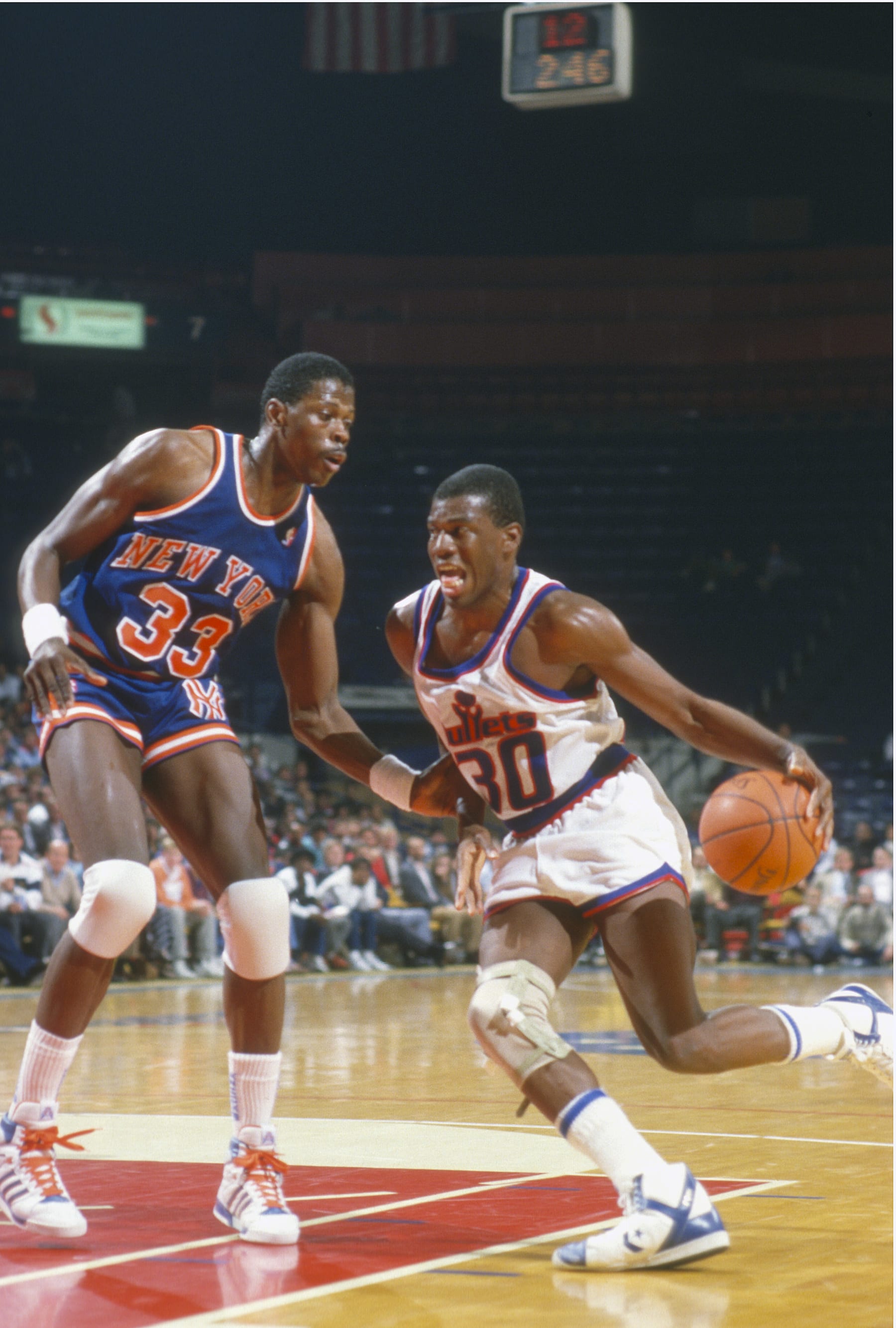 LANDOVER, MD - CIRCA 1989:  Bernard King #30 of the Washington Bullets drives on Patrick Ewing #33 of the New York Knicks during an NBA basketball game circa 1989 at the Capital Centre in Landover, Maryland. King played for the Bullets from 1987-91. (Photo by Focus on Sport/Getty Images) 