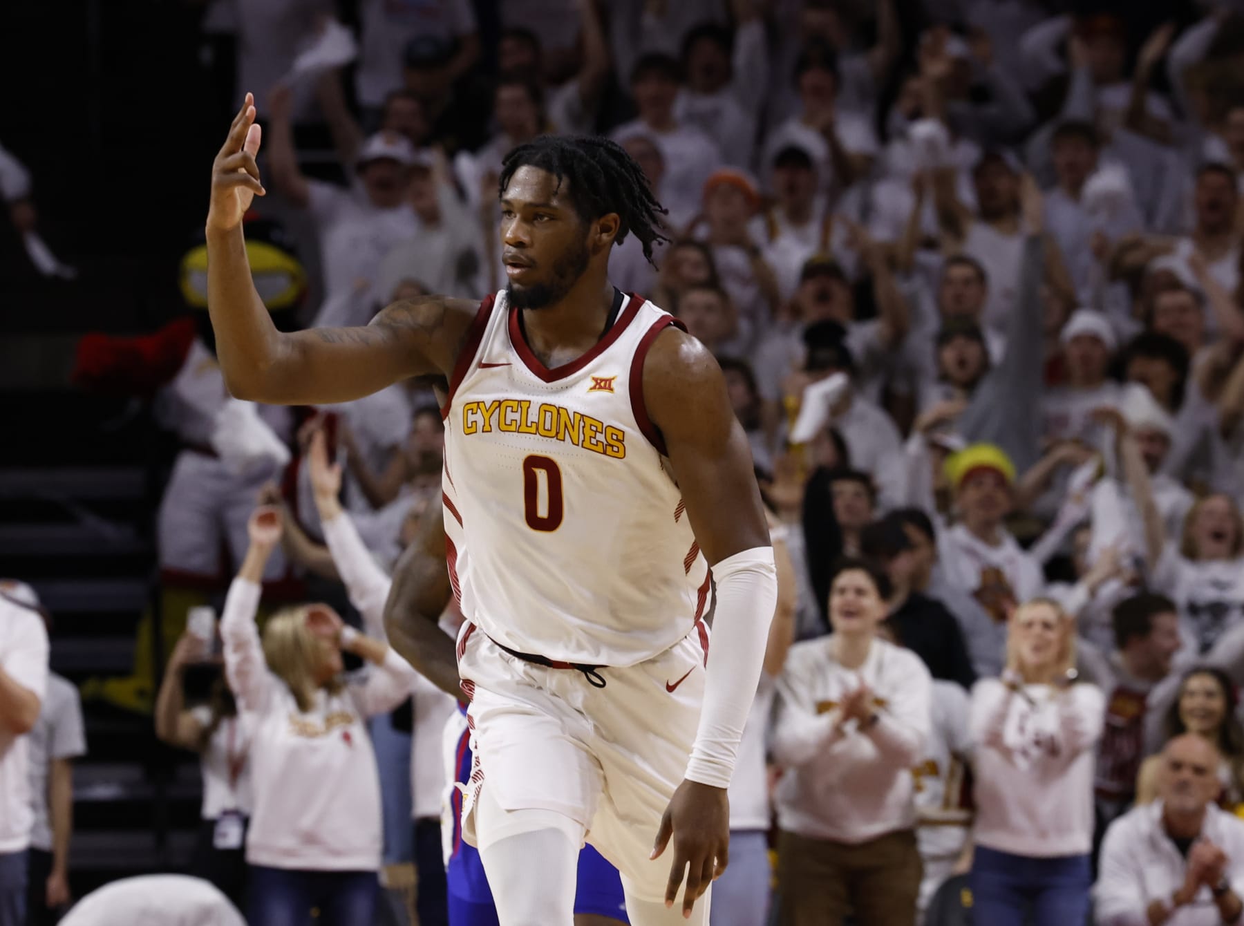 AMES, IA - JANUARY 27: Tre King #0 of the Iowa State Cyclones signals three points after sinking a three point basket in the second half of play at Hilton Coliseum on January 27, 2024 in Ames, Iowa. The Iowa State Cyclones won 79-75 over the Kansas Jayhawks. (Photo by David K Purdy/Getty Images)