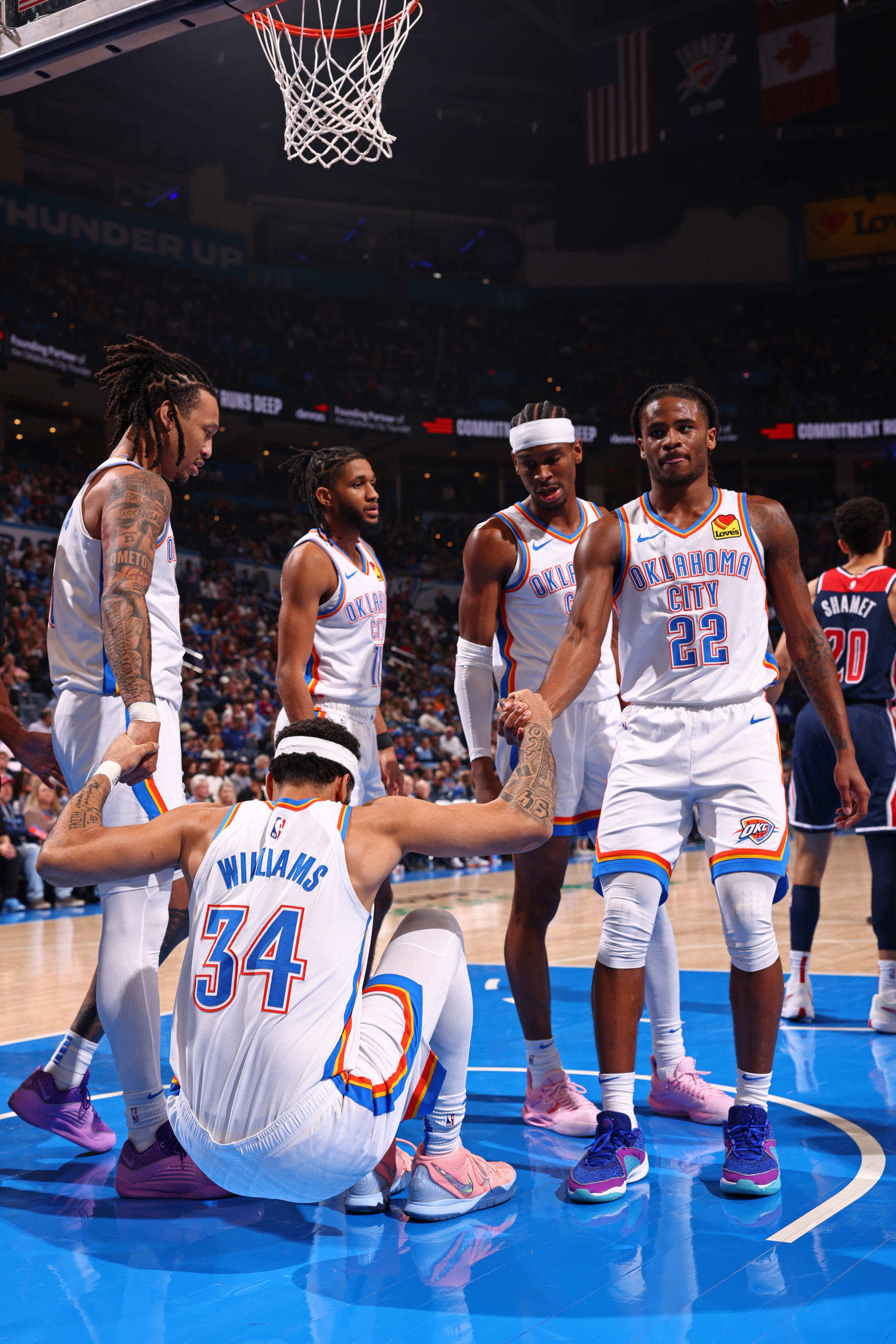 OKLAHOMA CITY, OK - FEBRUARY 23: Jaylin Williams #6 and Cason Wallace #22 of the Oklahoma City Thunder help up Kenrich Williams #34 during the game against the Washington Wizards on February 23, 2024 at Paycom Arena in Oklahoma City, Oklahoma. NOTE TO USER: User expressly acknowledges and agrees that, by downloading and or using this photograph, User is consenting to the terms and conditions of the Getty Images License Agreement. Mandatory Copyright Notice: Copyright 2024 NBAE (Photo by Zach Beeker/NBAE via Getty Images)