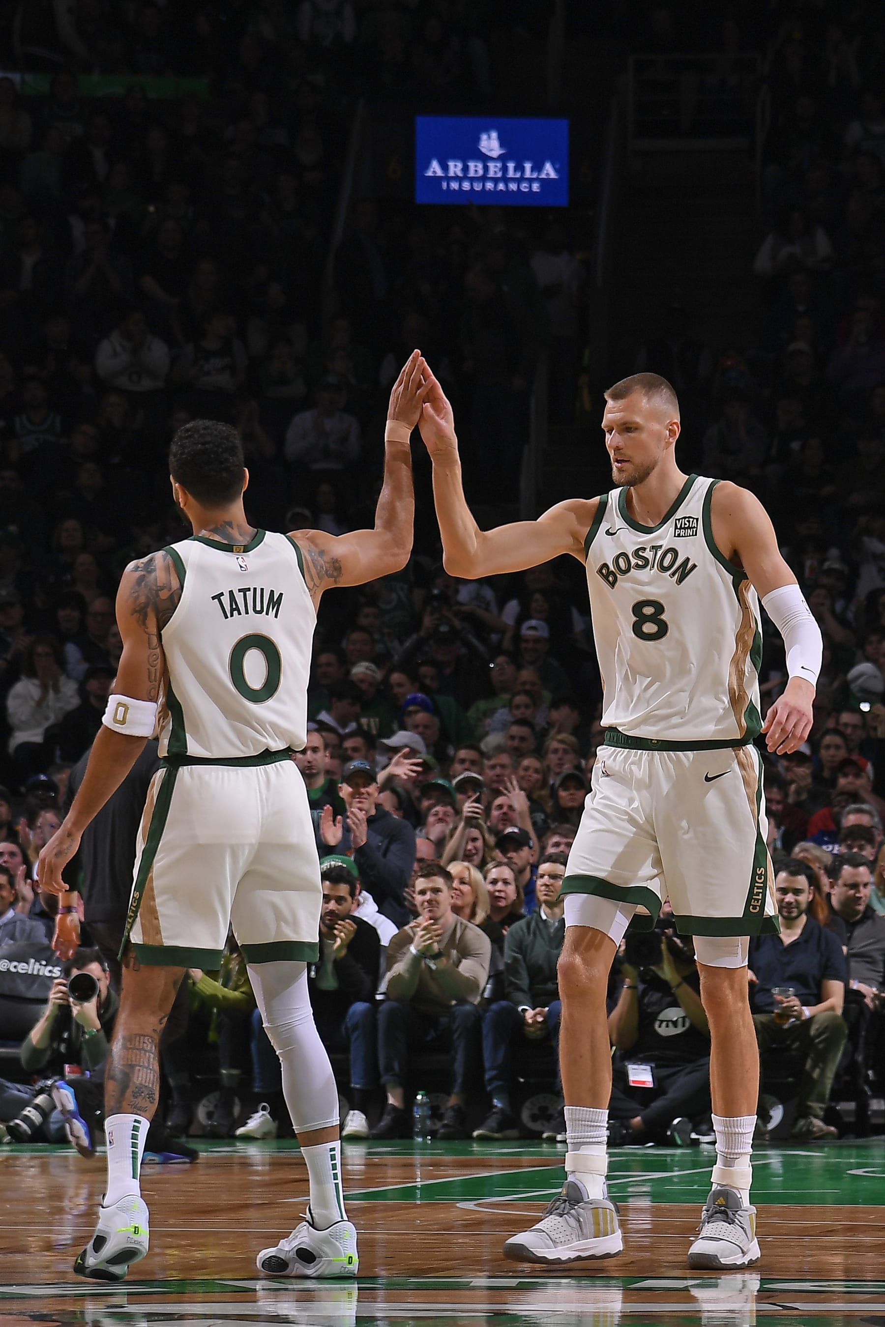 BOSTON, MA - FEBRUARY 27: Kristaps Porzingis #8 and Jayson Tatum #0 of the Boston Celtics high five during the game against the Philadelphia 76ers on February 27, 2024 at the TD Garden in Boston, Massachusetts. NOTE TO USER: User expressly acknowledges and agrees that, by downloading and or using this photograph, User is consenting to the terms and conditions of the Getty Images License Agreement. Mandatory Copyright Notice: Copyright 2024 NBAE  (Photo by Brian Babineau/NBAE via Getty Images)