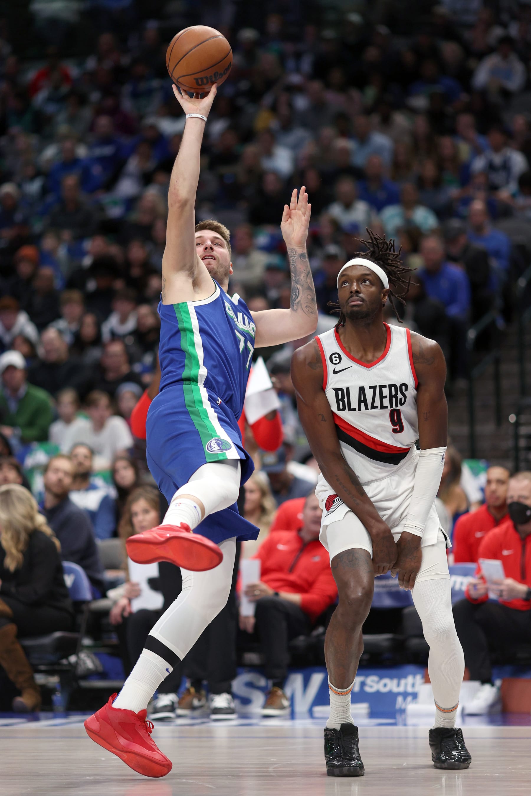 DALLAS, TEXAS - NOVEMBER 12: Luka Doncic #77 of the Dallas Mavericks shoots the ball against Jerami Grant #9 of the Portland Trail Blazers in the fourth quarter at American Airlines Center on November 12, 2022 in Dallas, Texas. NOTE TO USER: User expressly acknowledges and agrees that, by downloading and or using this photograph, User is consenting to the terms and conditions of the Getty Images License Agreement. (Photo by Tom Pennington/Getty Images)