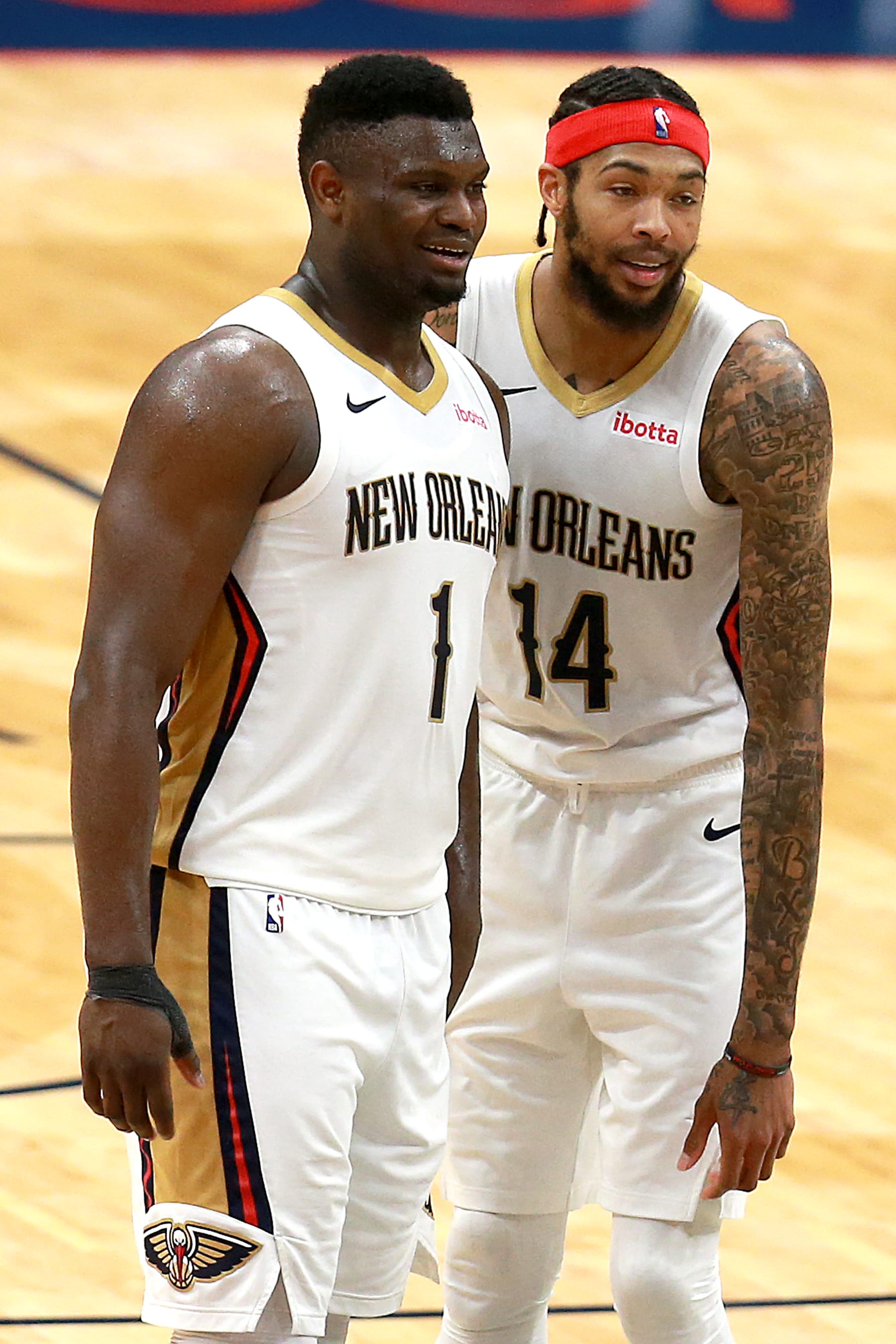NEW ORLEANS, LOUISIANA - APRIL 12: Zion Williamson #1 of the New Orleans Pelicans and Brandon Ingram #14 of the New Orleans Pelicans stand on the court during the fourth quarter of an NBA game against the Sacramento Kings at Smoothie King Center on April 12, 2021 in New Orleans, Louisiana. The New Orleans Pelicans won the game 117 - 110. NOTE TO USER: User expressly acknowledges and agrees that, by downloading and or using this photograph, User is consenting to the terms and conditions of the Getty Images License Agreement. (Photo by Sean Gardner/Getty Images)