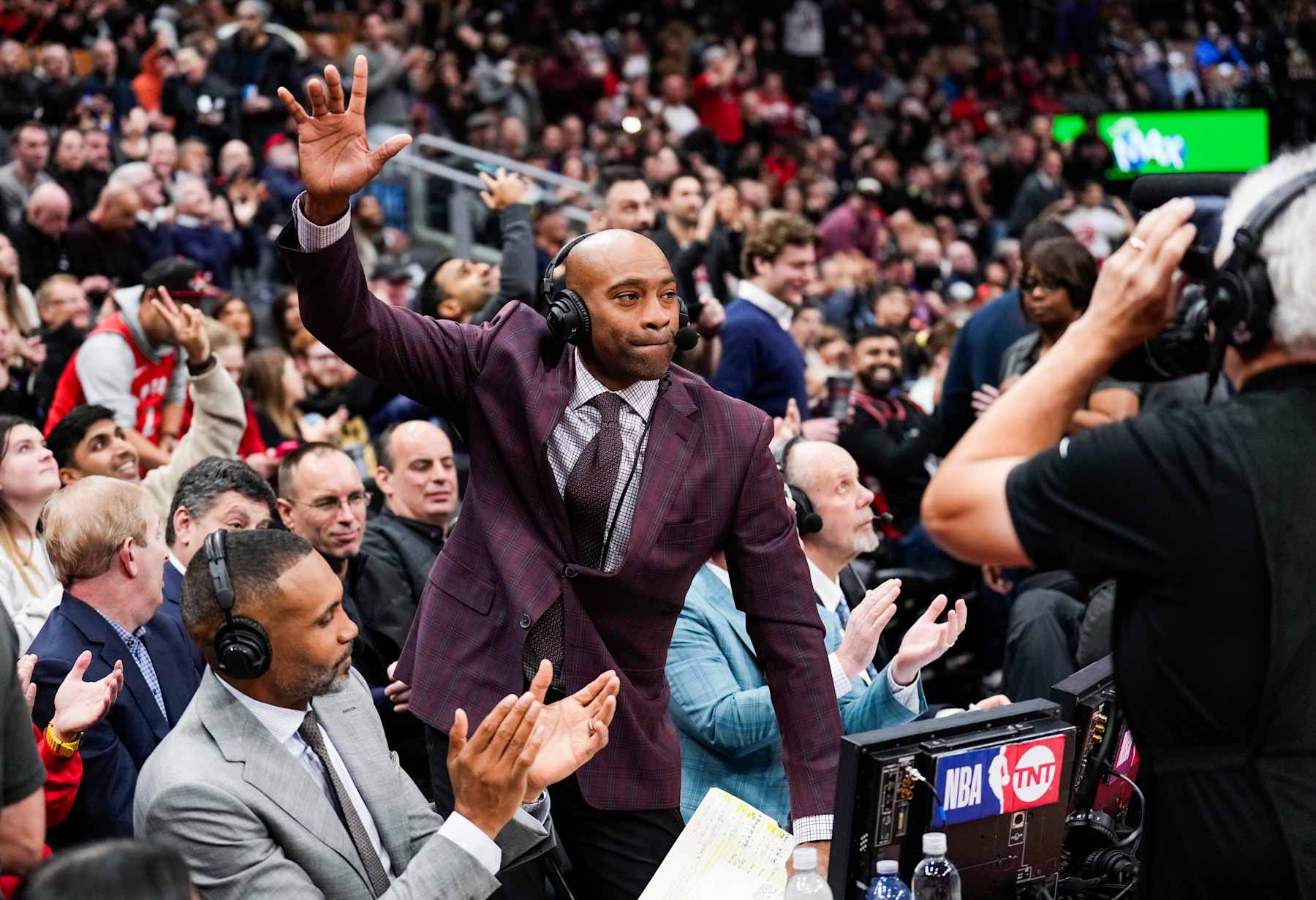 TORONTO, ON - JANUARY 18: Vince Carter, TNT commentator and former Toronto Raptors player salutes the crowd in a break in play between the Toronto Raptors and Chicago Bulls at the Scotiabank Arena on January 18, 2024 in Toronto, Ontario, Canada. NOTE TO USER: User expressly acknowledges and agrees that, by downloading and/or using this Photograph, user is consenting to the terms and conditions of the Getty Images License Agreement. (Photo by Mark Blinch/Getty Images)