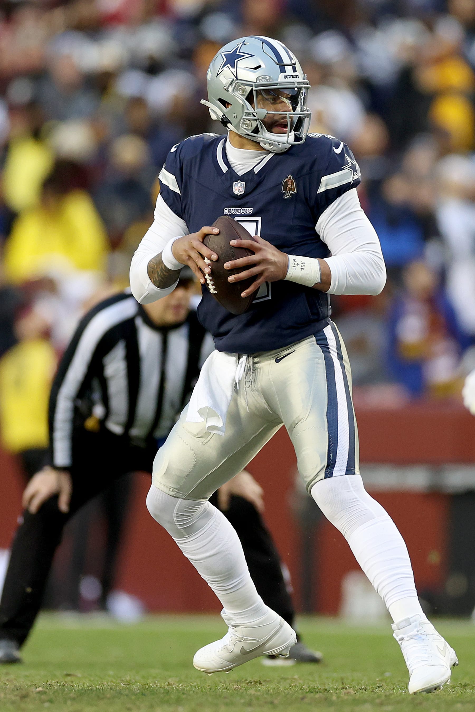 LANDOVER, MARYLAND - JANUARY 07: Dak Prescott #4 of the Dallas Cowboys looks to pass during the first quarter against the Washington Commanders at FedExField on January 07, 2024 in Landover, Maryland. (Photo by Patrick Smith/Getty Images)