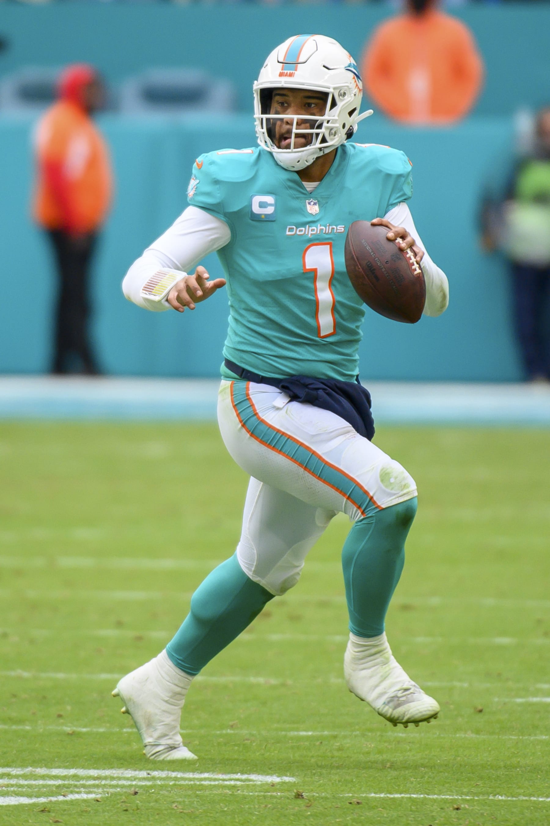 Miami Dolphins quarterback Tua Tagovailoa (1) runs with the ball during an NFL football game against the Green Bay Packers, Sunday, Dec. 25, 2022, in Miami Gardens, Fla. (AP Photo/Doug Murray)