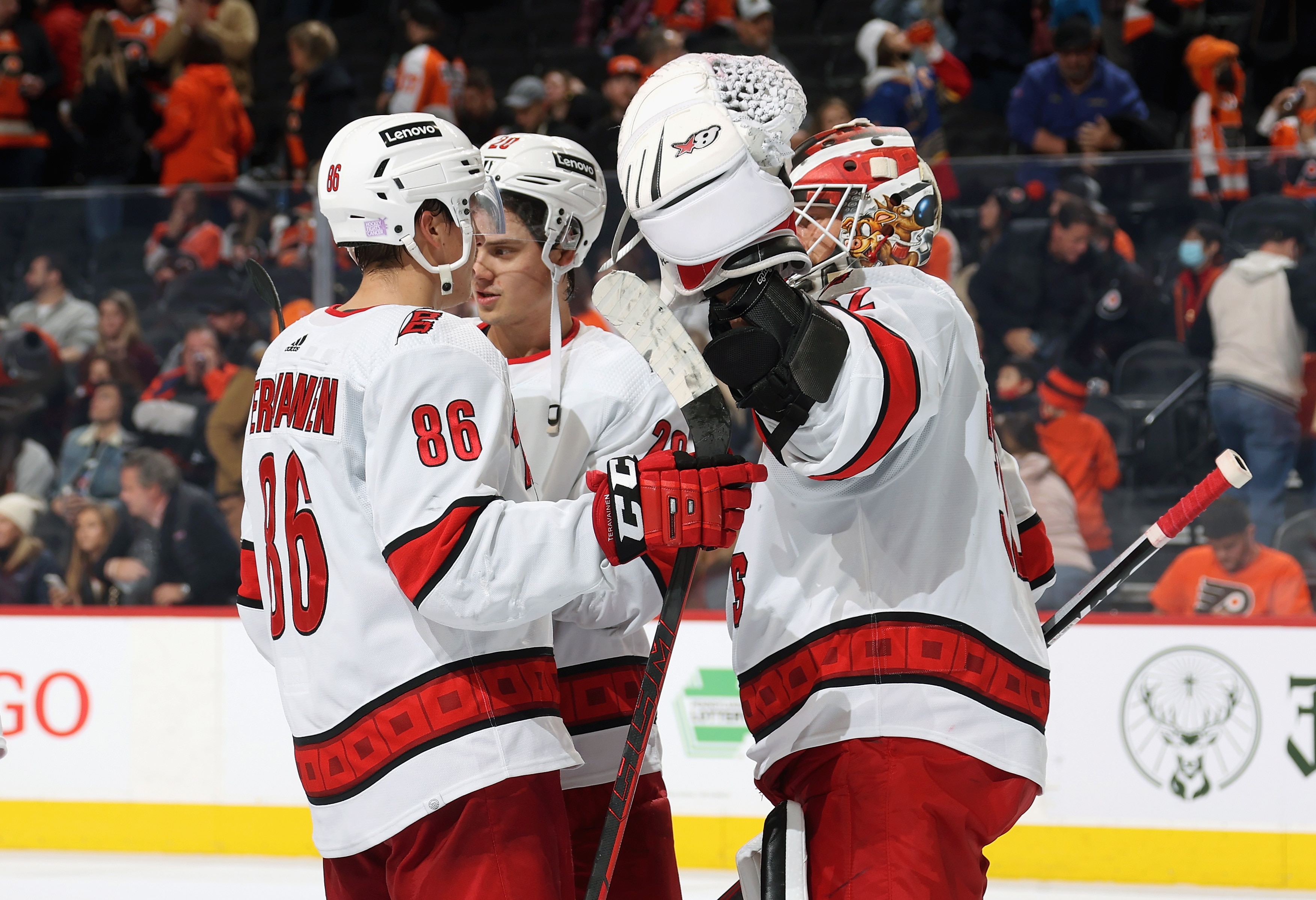PHILADELPHIA, PA - NOVEMBER 26: Teuvo Teravainen #86, Sebastian Aho #20, and Antti Raanta #32 of the Carolina Hurricanes celebrate after defeating the Philadelphia Flyers 6-3 at the Wells Fargo Center on November 26, 2021 in Philadelphia, Pennsylvania.  (Photo by Len Redkoles/NHLI via Getty Images)