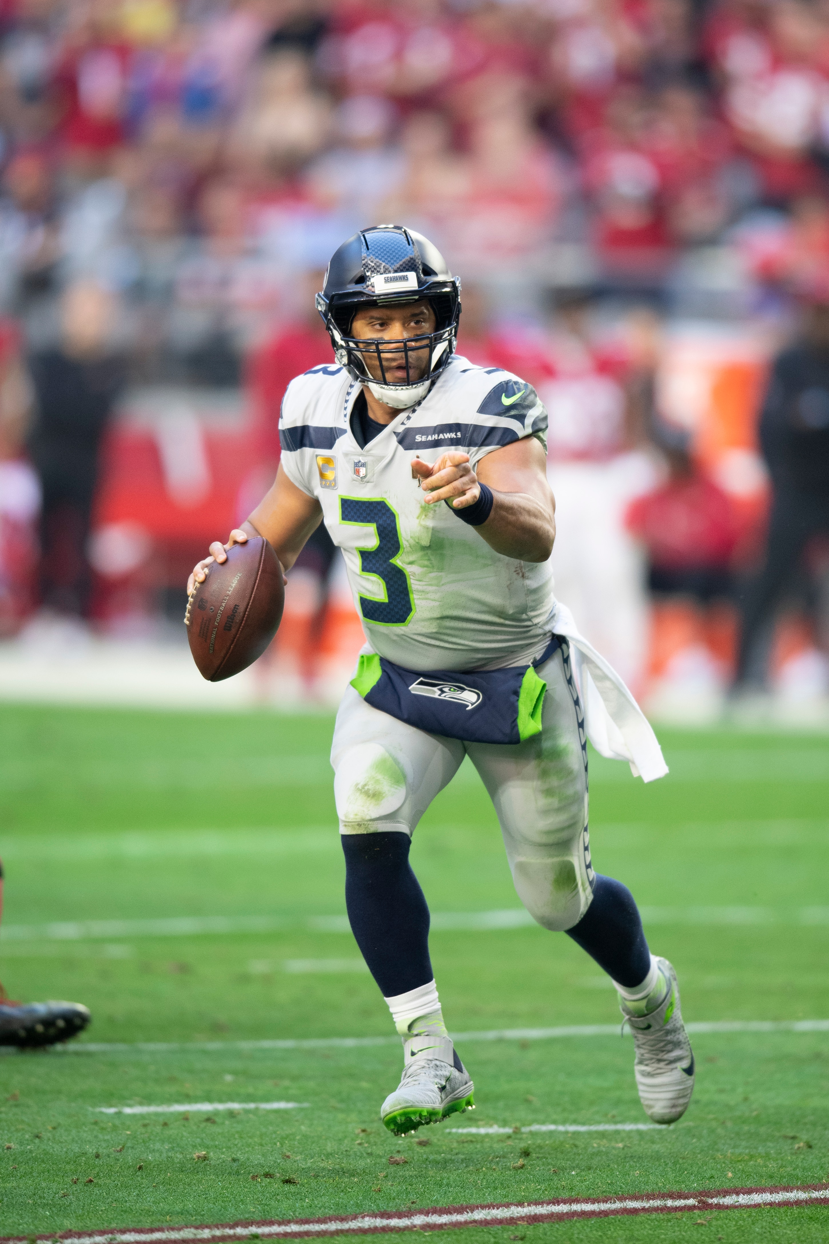 Seattle Seahawks quarterback Russell Wilson (3) scrambles against the Arizona Cardinals during an NFL Professional Football Game Sunday, Jan. 9, 2022, in Phoenix. (AP Photo/John McCoy)