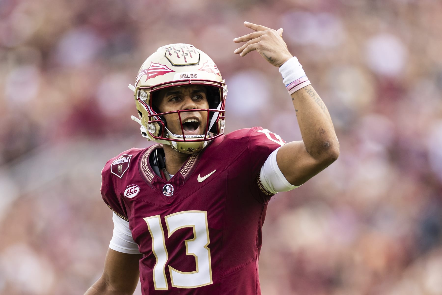 TALLAHASSEE, FLORIDA - NOVEMBER 11: Jordan Travis #13 of the Florida State Seminoles reacts during the first half of a game against the Miami Hurricanes at Doak Campbell Stadium on November 11, 2023 in Tallahassee, Florida. (Photo by James Gilbert/Getty Images)