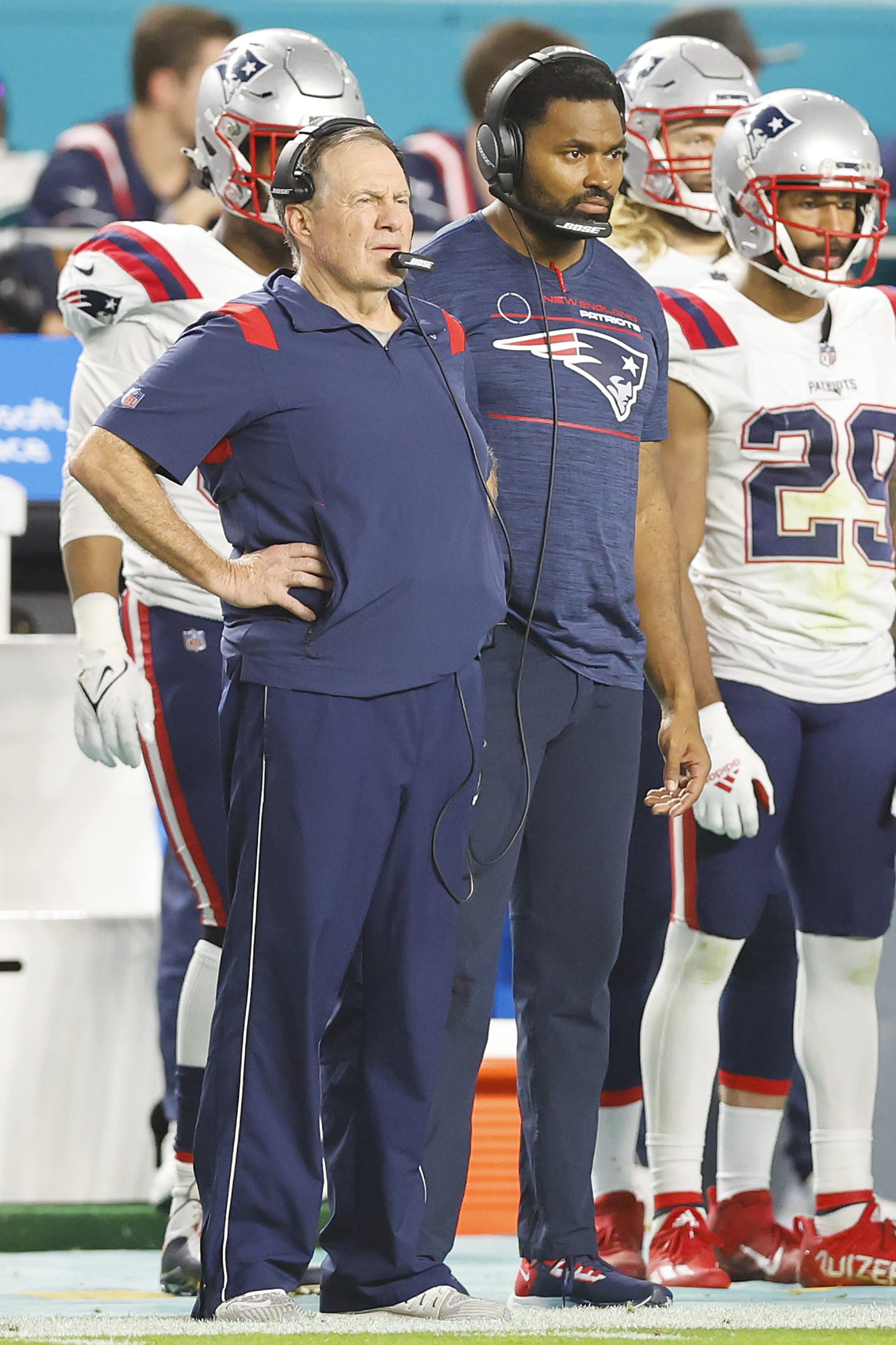 MIAMI GARDENS, FLORIDA - JANUARY 09: Head coach Bill Belichick and outside linebackers coach Jerod Mayo of the New England Patriots look on against the Miami Dolphins during the fourth quarter at Hard Rock Stadium on January 09, 2022 in Miami Gardens, Florida. (Photo by Michael Reaves/Getty Images)