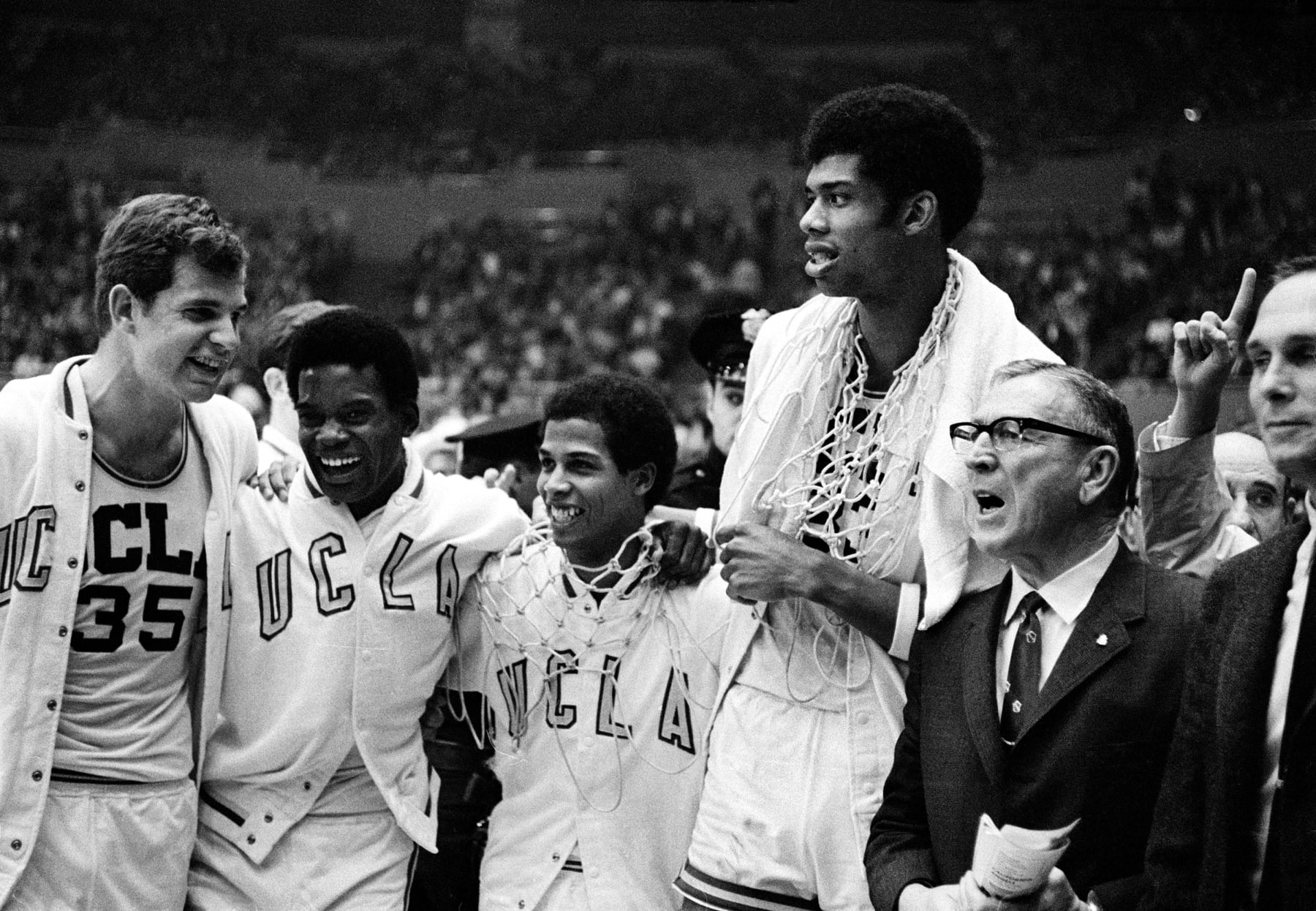 UCLA coach John Wooden, right, wearing eyeglasses, celebrates with his players, from left, Mike Lynn, Lucius Allen, Mike Warren and Lew Alcindor after the Bruins beat North Carolina, 78-55, to win the NCAA championship final at the Los Angeles Sports Arena, Ca., March 23, 1968. It is the second straight national collegiate basketball title for the Bruins. (AP Photo)