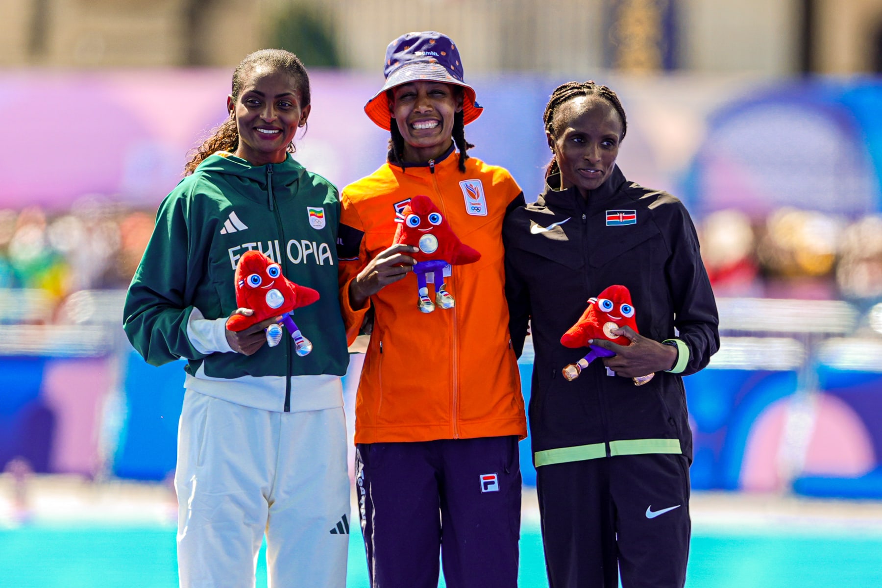 PARIS, FRANCE - AUGUST 11: Tigist Assefa of Ethiopia, Sifan Hassan of the Netherlands, Hellen Obiri of Kenya celebrate competing in the Women's Marathon - Winning ceremony during Day 16 of Athletics Marathon - Olympic Games Paris 2024 at Esplanade Des Invalides on August 11, 2024 in Paris, France. (Photo by Joris Verwijst/BSR Agency/Getty Images)