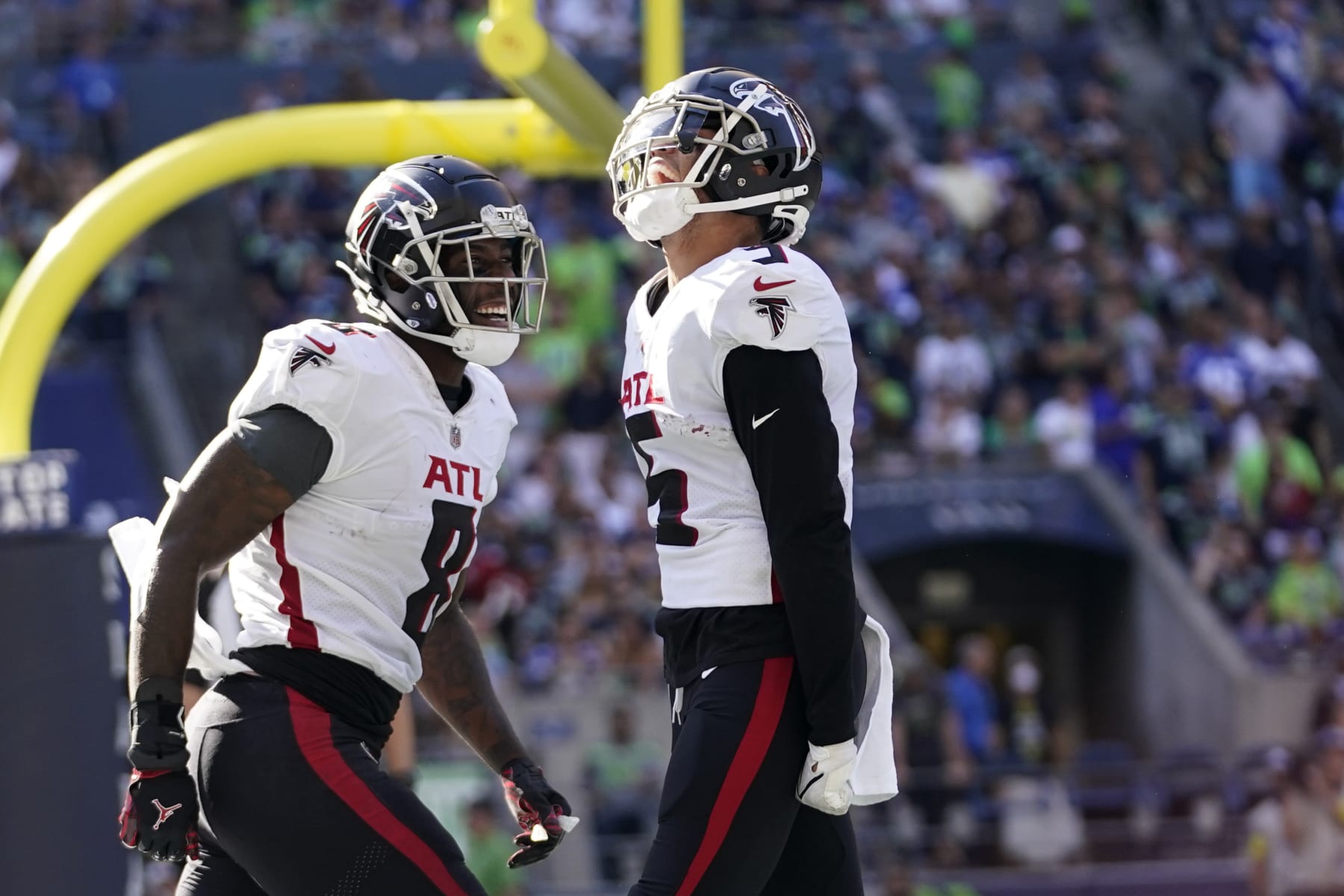 Atlanta Falcons wide receiver Drake London, right, reacts with teammate tight end Kyle Pitts after scoring a touchdown during the second half of an NFL football game against the Atlanta Falcons, Sunday, Sept. 25, 2022, in Seattle. (AP Photo/Ashley Landis)