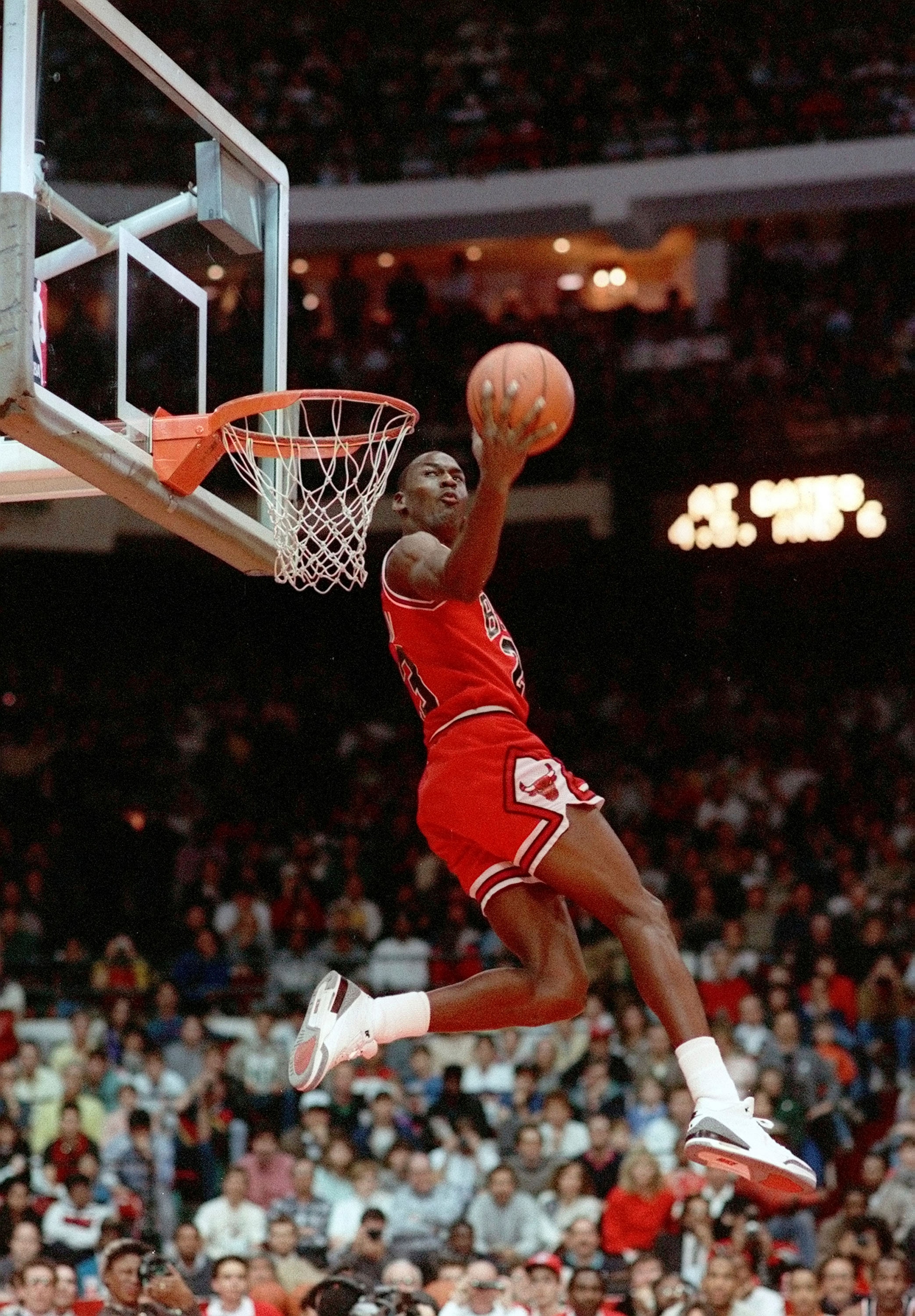 FILE - In this Feb. 6, 1988, file photo, Chicago Bulls' Michael Jordan dunks during the slam-dunk competition of the NBA All-Star weekend in Chicago.  Jordan left the old Chicago Stadium that night with the trophy. To this day, many believe Wilkins was the rightful winner.  (AP Photo/John Swart)