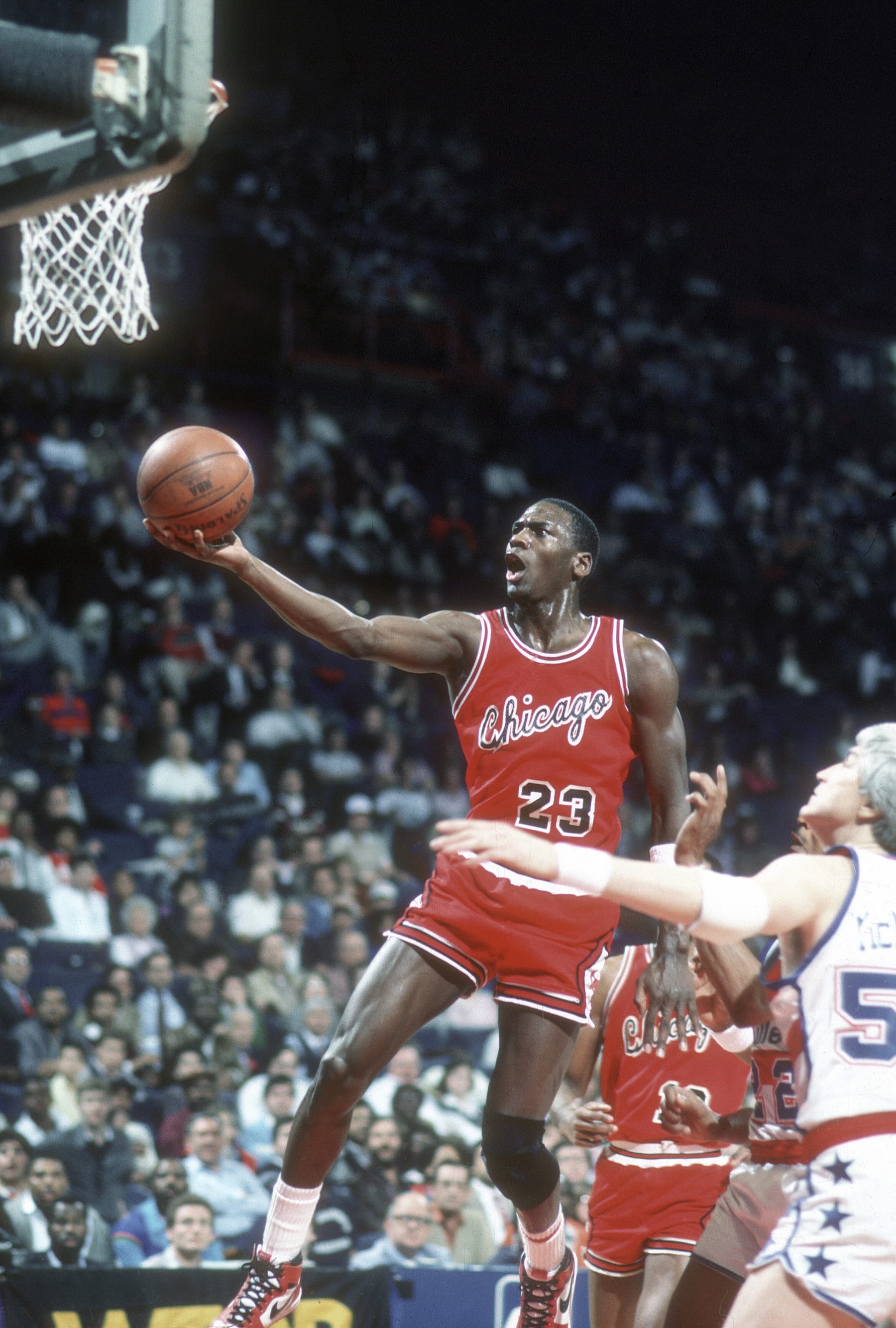 LANDOVER, MD - CIRCA 1985: Michael Jordan #23 of the Chicago Bulls goes in for a layup against the Washington Bullets during an NBA basketball game circa 1985 at the Capital Centre in Landover, Maryland. Jordan played for the Bulls from 1984-93 and 1995 - 98. (Photo by Focus on Sport/Getty Images) *** Local Caption *** Michael Jordan