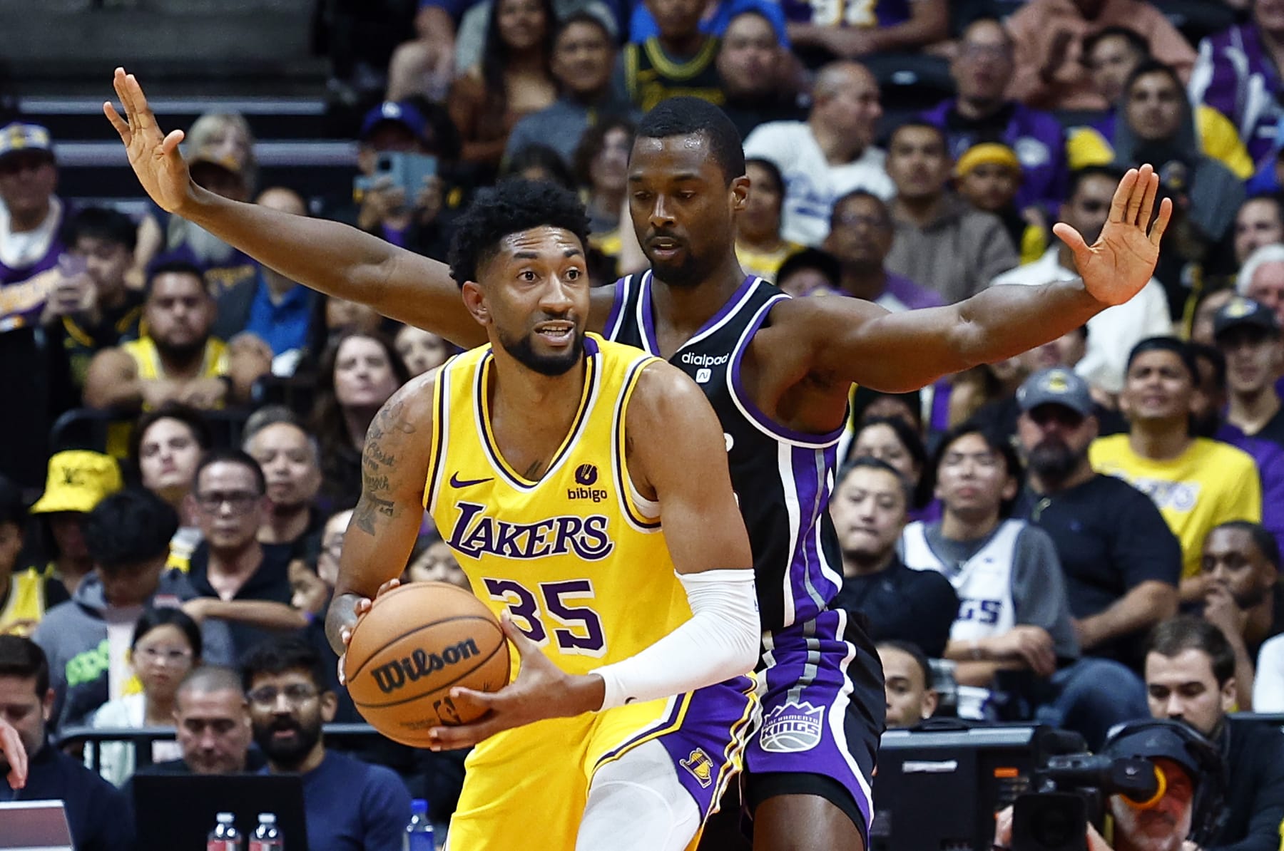 ANAHEIM, CALIFORNIA - OCTOBER 11:  Christian Wood #35 of the Los Angeles Lakers controls the ball against Harrison Barnes #40 of the Sacramento Kings in the first half at Honda Center on October 11, 2023 in Anaheim, California.  NOTE TO USER: User expressly acknowledges and agrees that, by downloading and/or using this photograph, user is consenting to the terms and conditions of the Getty Images License Agreement. (Photo by Ronald Martinez/Getty Images)