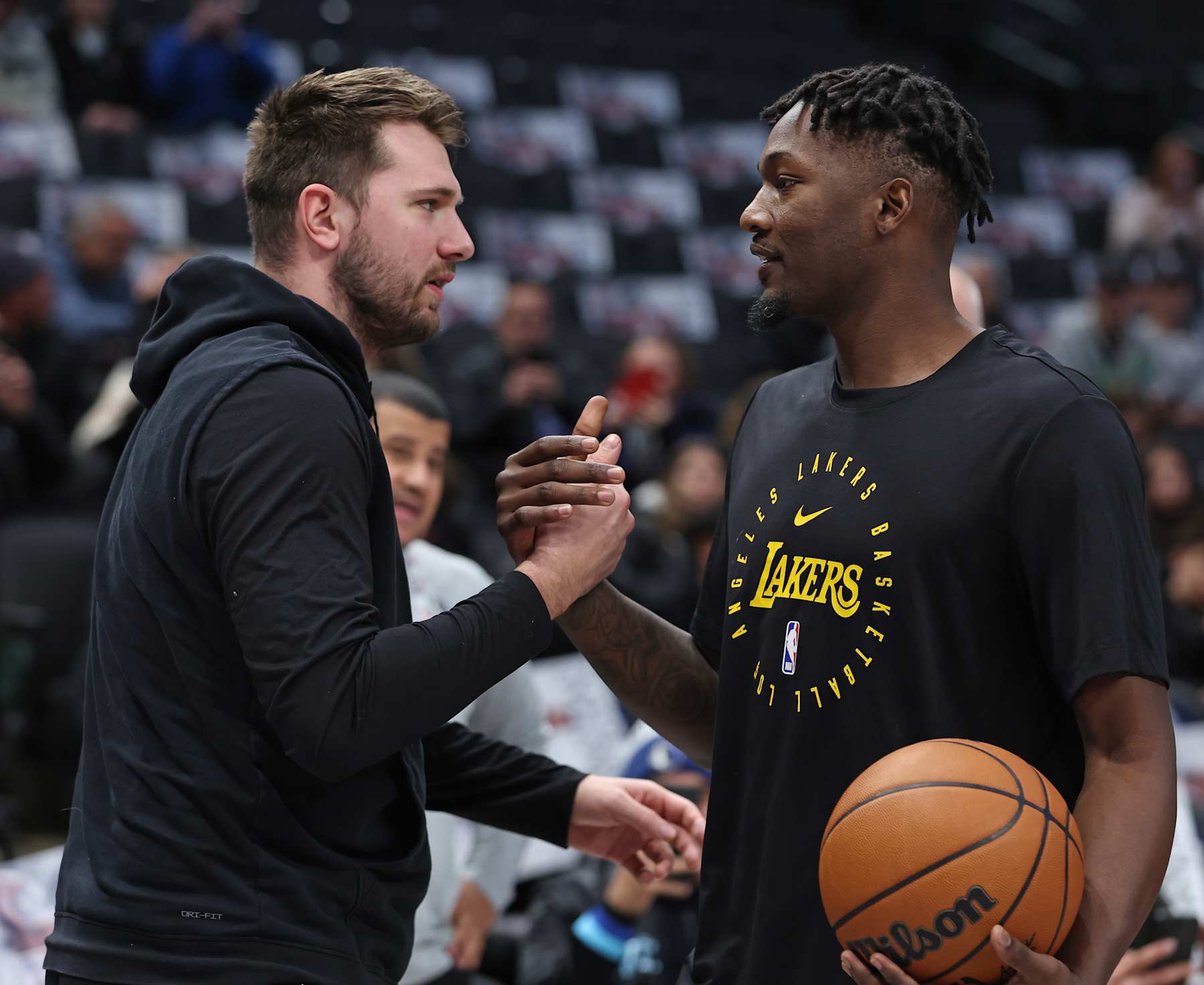 DALLAS, TX - JANUARY 7: Luka Doncic #77 of the Dallas Mavericks and Dorian Finney-Smith #17 of the Los Angeles Lakers high five before the game on January 7, 2025 at American Airlines Center in Dallas, Texas. NOTE TO USER: User expressly acknowledges and agrees that, by downloading and or using this photograph, User is consenting to the terms and conditions of the Getty Images License Agreement. Mandatory Copyright Notice: Copyright 2025 NBAE (Photo by Tim Heitman/NBAE via Getty Images)