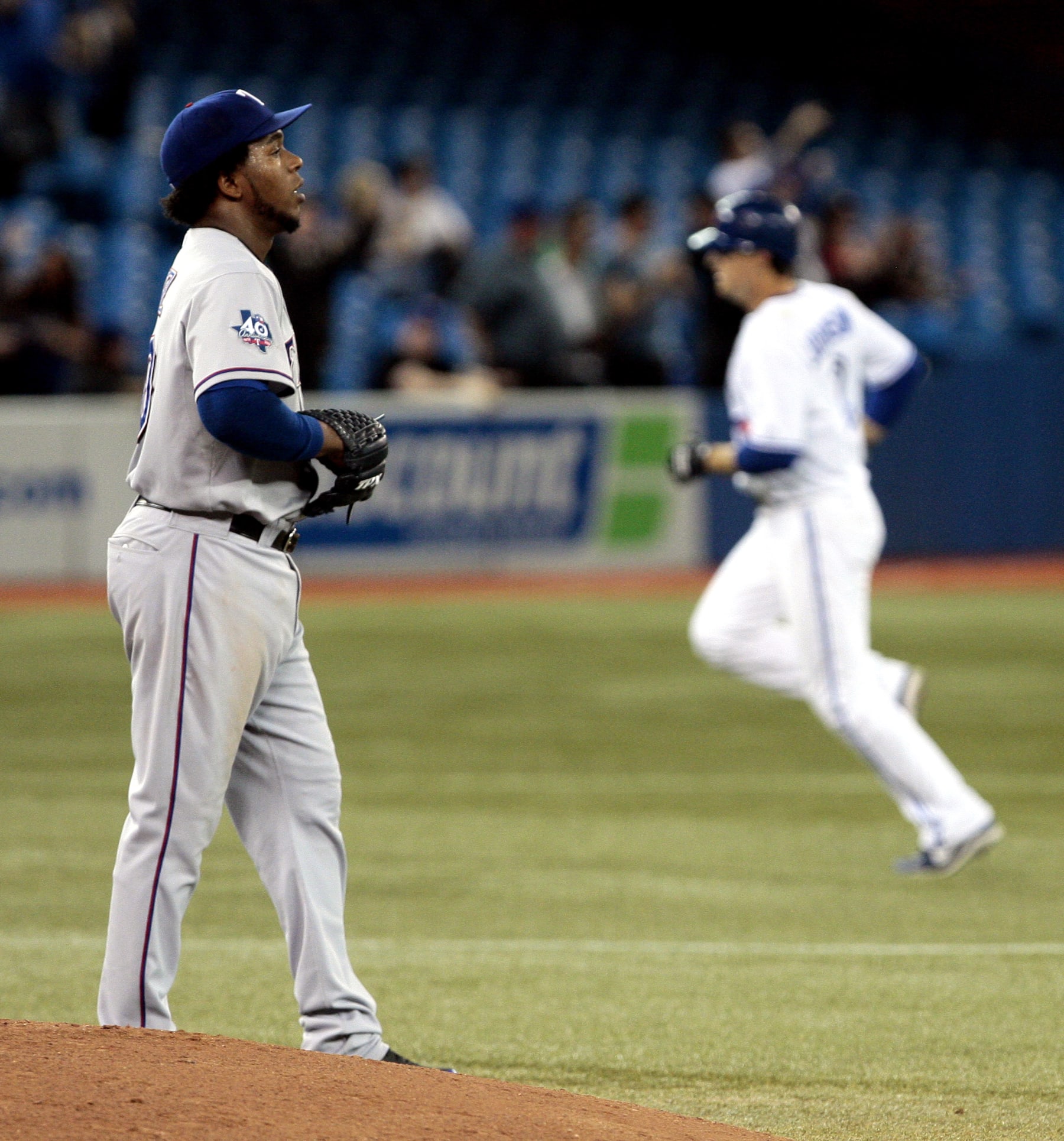TORONTO, CANADA - MAY 1: Neftali Feliz #30 of the Texas Rangers reacts as Kelly Johnson #2 of the Toronto Blue Jays rounds the bases after hitting a three-run homer during MLB action at the Rogers Centre May 1, 2012 in Toronto, Ontario, Canada.  (Photo by Abelimages/Getty Images)