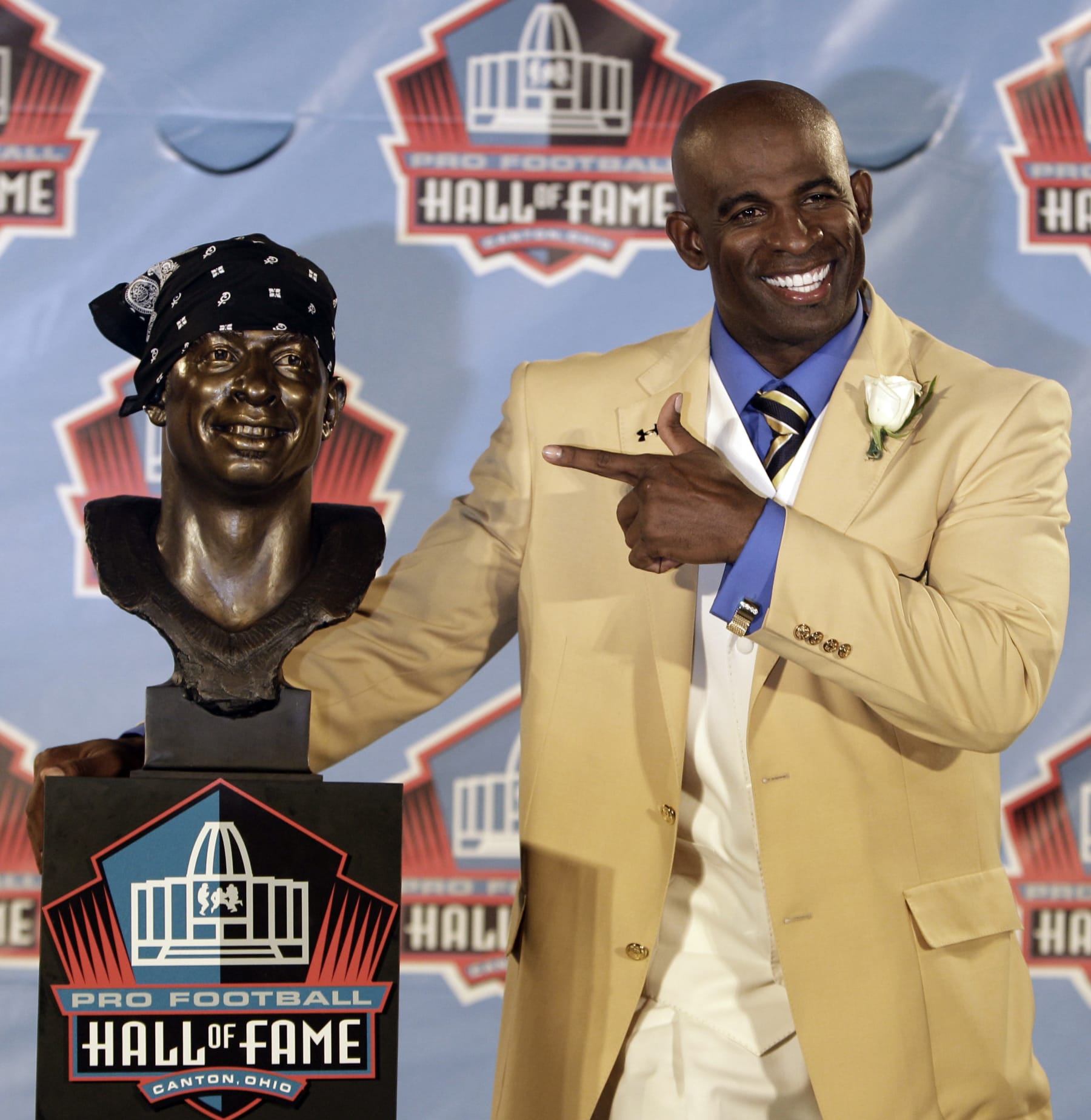 Deion Sanders poses with a bust of himself during the induction ceremony at the Pro Football Hall of Fame, Saturday, Aug. 6, 2011, in Canton, Ohio. (AP Photo/Tony Dejak)