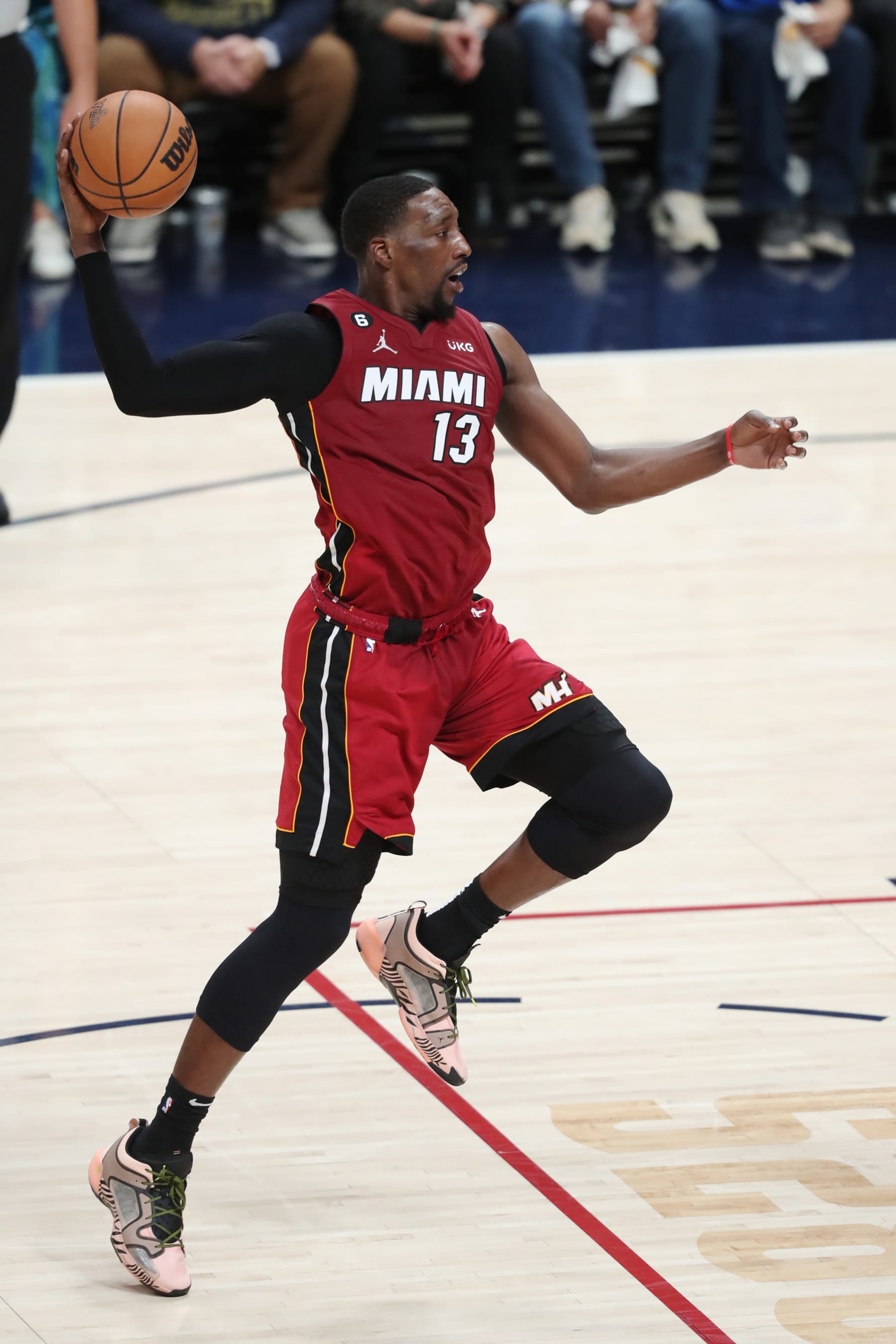DENVER, CO - JUNE 12: Bam Adebayo #13 of the Miami Heat passes the ball during game 5 of the 2023 NBA Finals against the Denver Nuggets on June 12, 2023 at the Ball Arena in Denver, Colorado. NOTE TO USER: User expressly acknowledges and agrees that, by downloading and/or using this Photograph, user is consenting to the terms and conditions of the Getty Images License Agreement. Mandatory Copyright Notice: Copyright 2023 NBAE (Photo by Issac Baldizon/NBAE via Getty Images)
