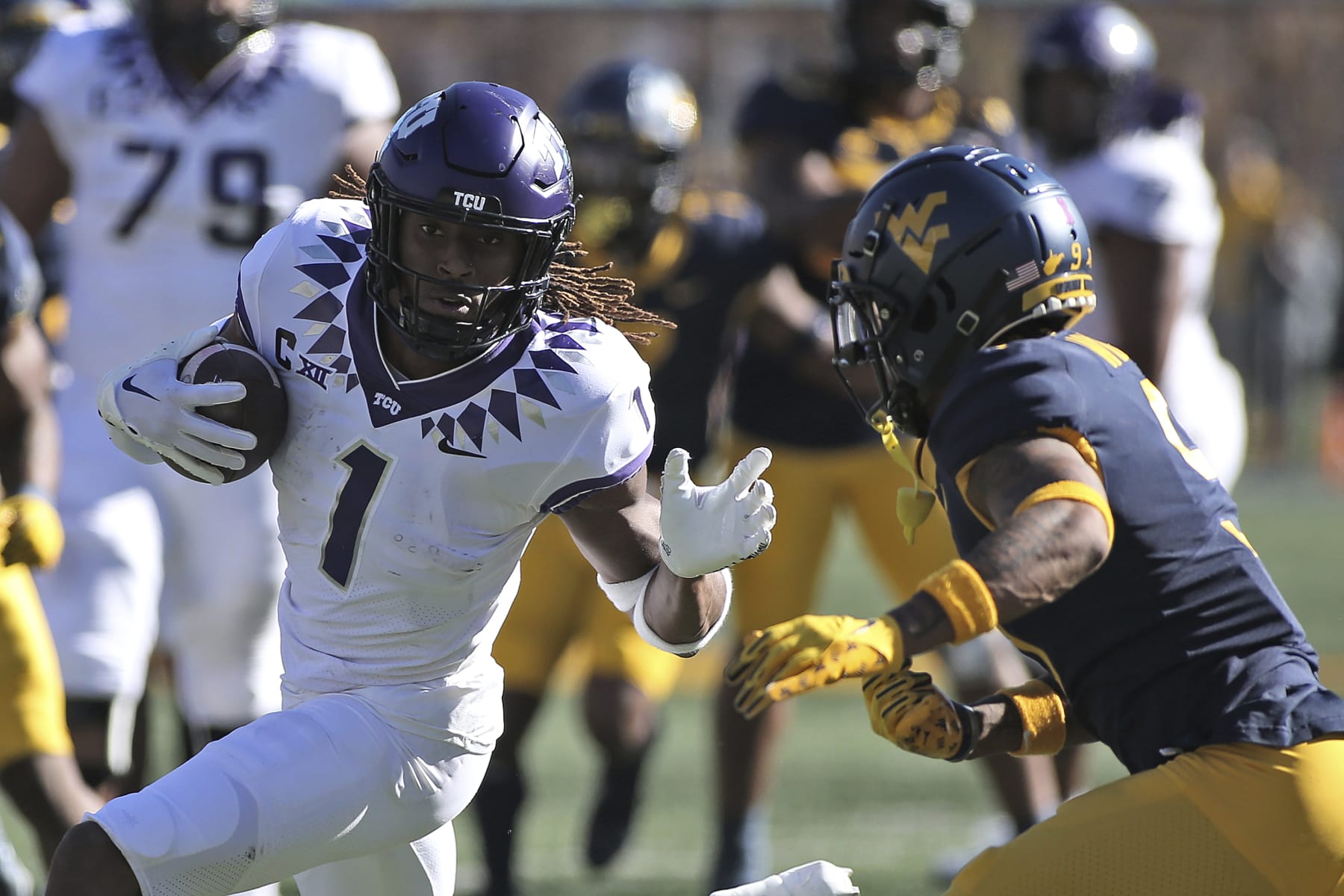 TCU wide receiver Quentin Johnston (1) is defended by West Virginia cornerback Charles Woods (9) during the second half of an NCAA college football game in Morgantown, W.Va., Saturday, Oct. 29, 2022. (AP Photo/Kathleen Batten)