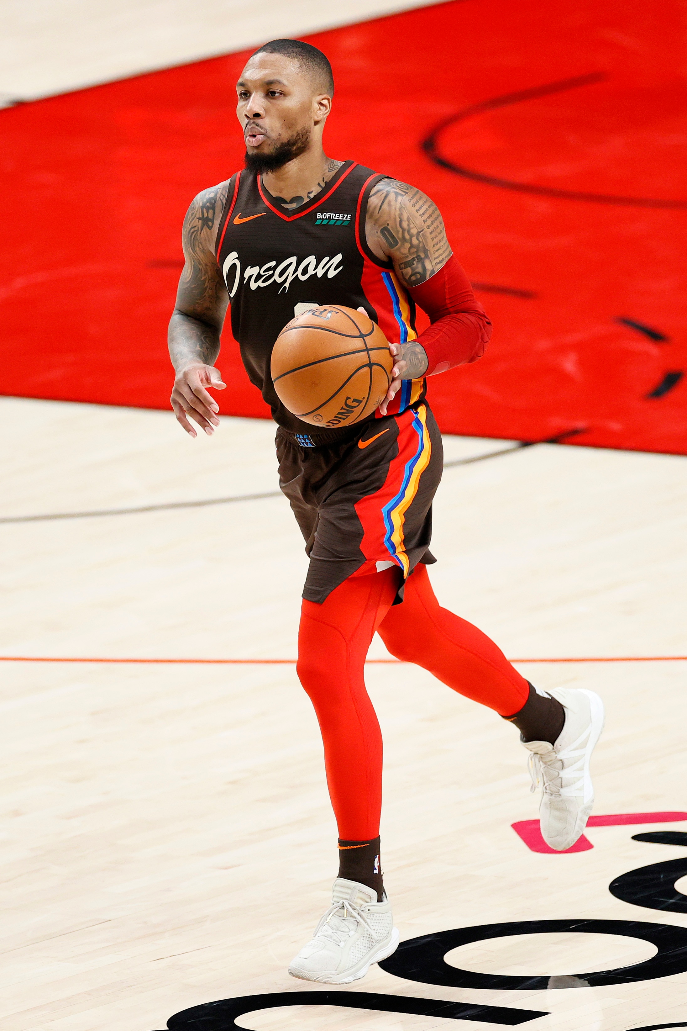 PORTLAND, OREGON - JUNE 03: Damian Lillard #0 of the Portland Trail Blazers dribbles against the Denver Nuggets in the second quarter during Round 1, Game 6 of the 2021 NBA Playoffs at Moda Center on June 03, 2021 in Portland, Oregon. NOTE TO USER: User expressly acknowledges and agrees that, by downloading and or using this photograph, User is consenting to the terms and conditions of the Getty Images License Agreement. (Photo by Steph Chambers/Getty Images)